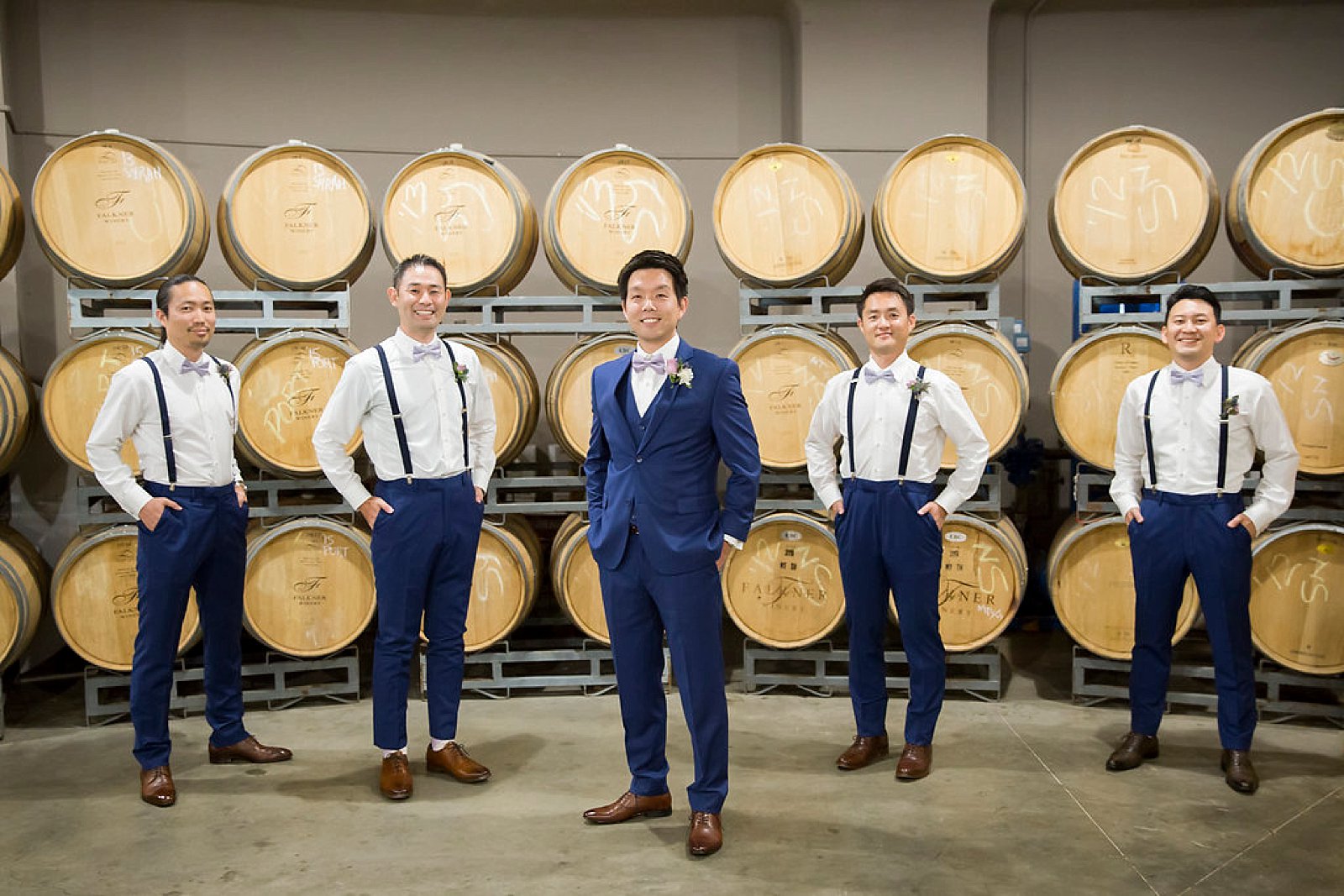 Groom in Falkner Winery barrel room photographed by Randi Michelle Photography