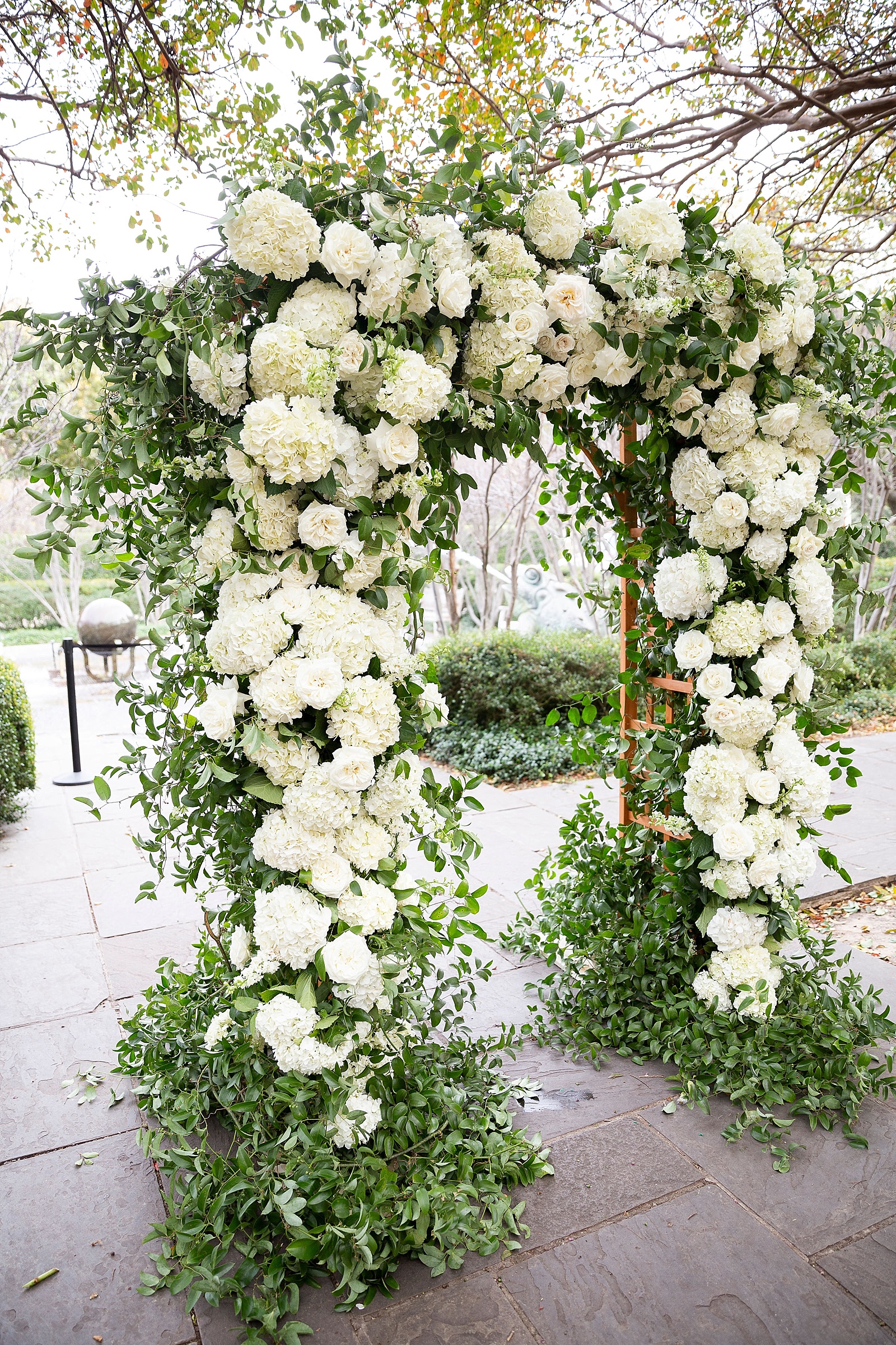 Ivory floral arch for outdoor wedding ceremony photographed by Randi Michelle Photography