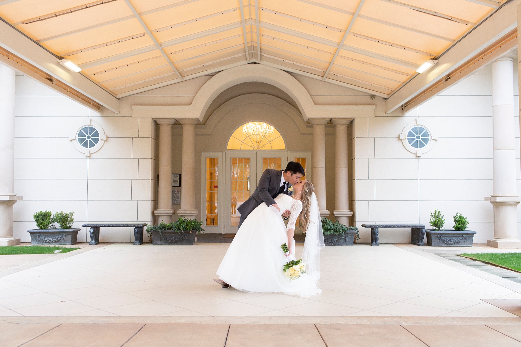 bride and groom kiss outside Ashton Gardens with Randi Michelle Weddings