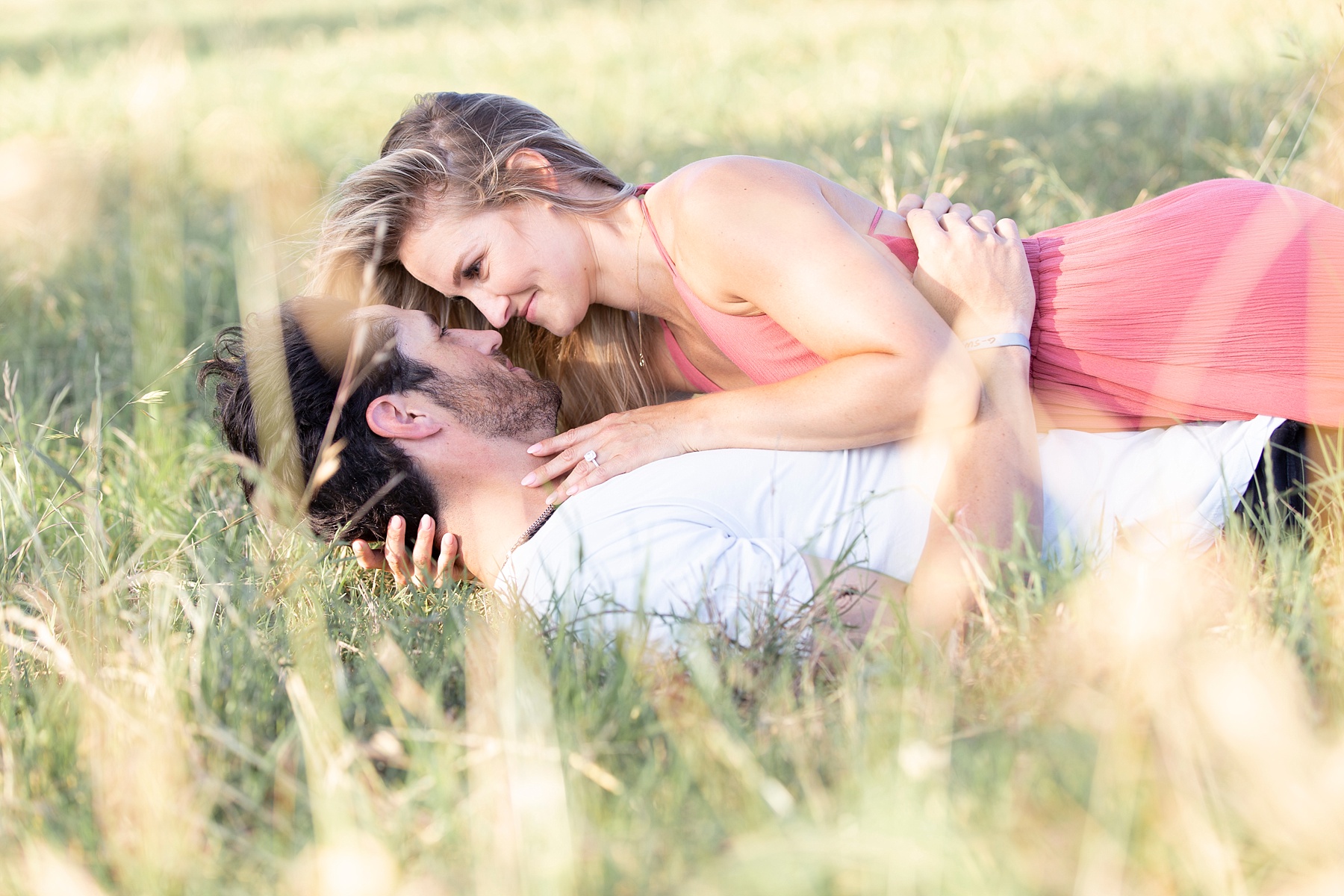 couple embraces in grass photographed by Randi Michelle