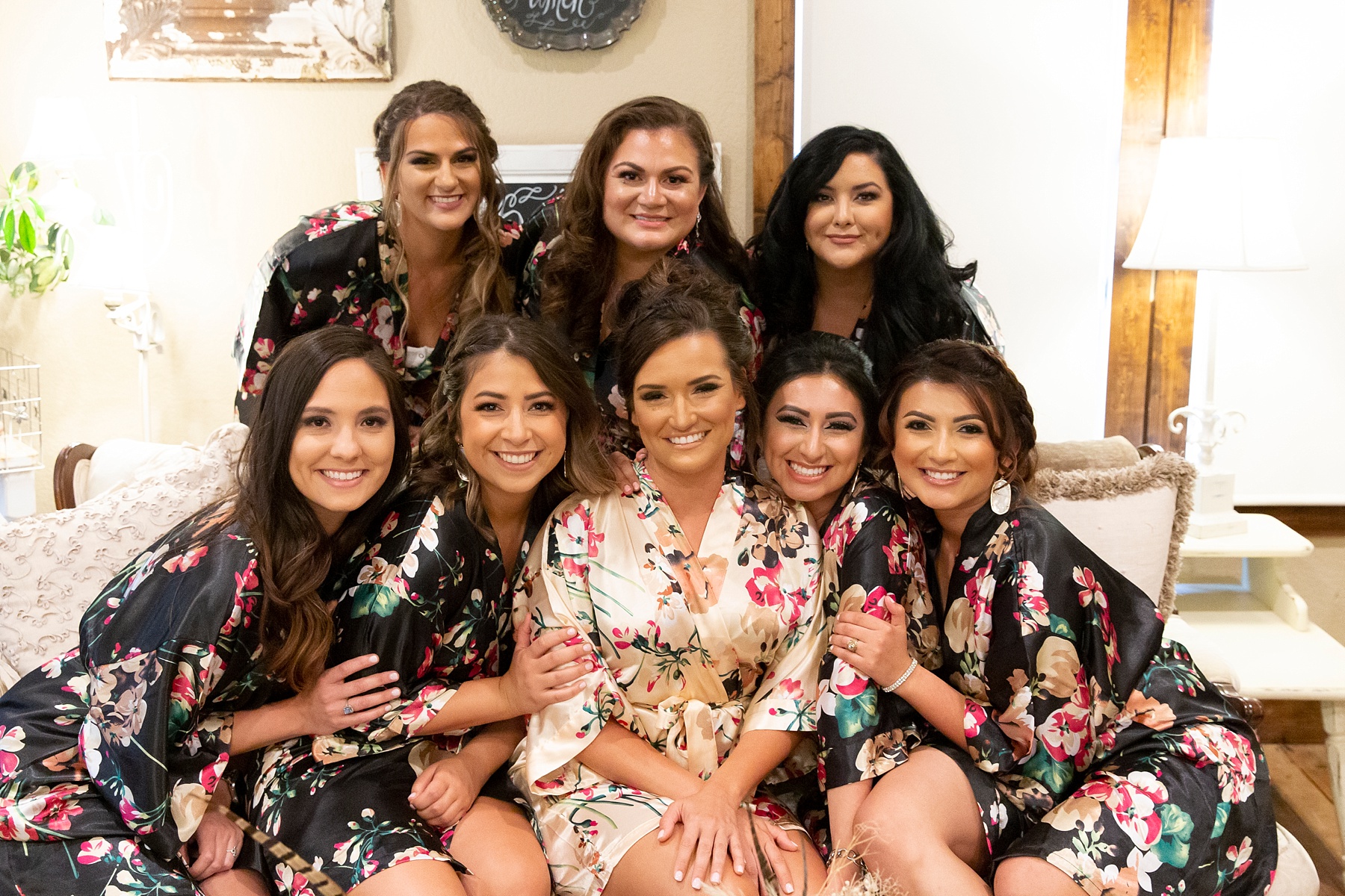 bridesmaids pose with bride in floral robes at the Brooks at Weatherford photographed by Randi Michelle