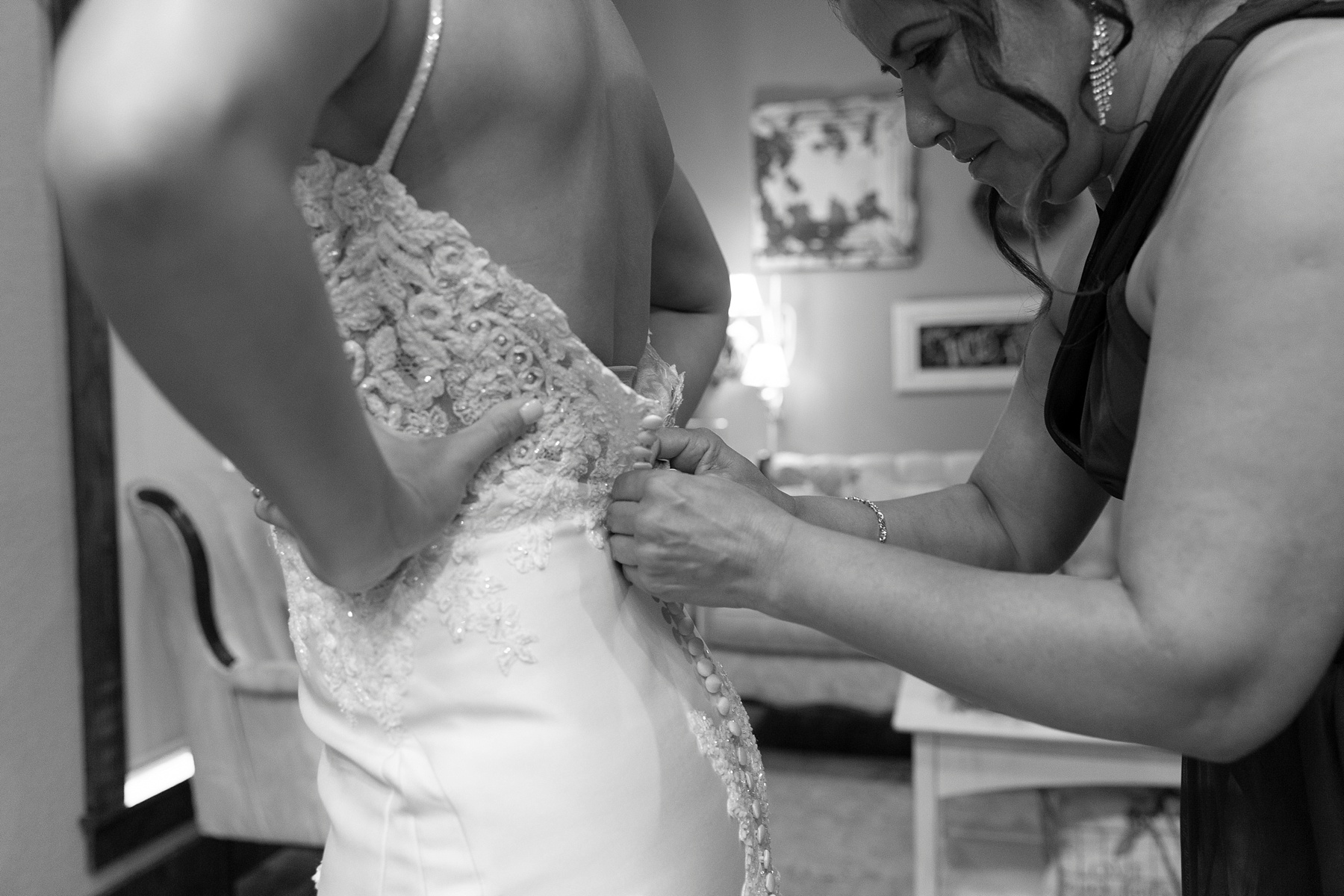 bride gets into wedding dress with help of bridesmaids photographed by Randi Michelle Weddings