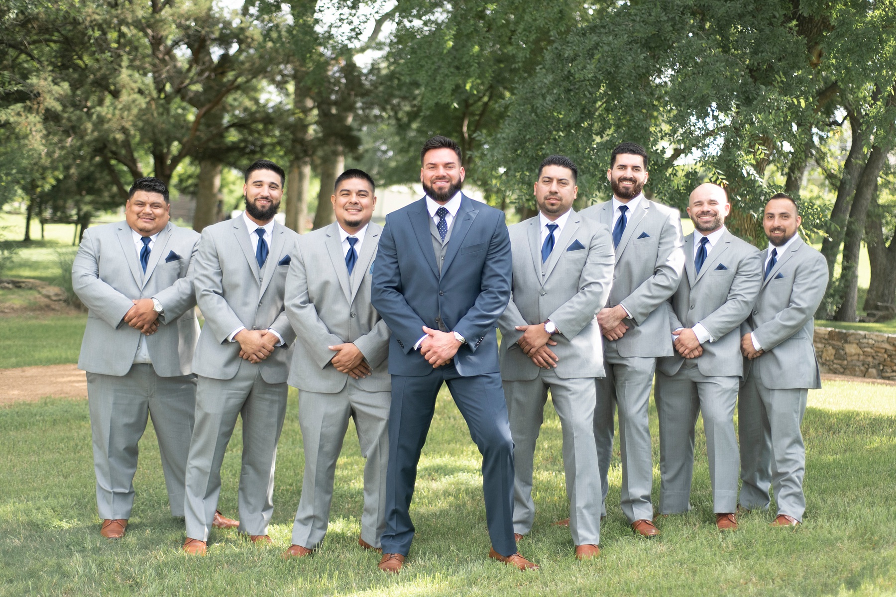 groomsmen pose with groom at the Brooks at Weatherford photographed by Randi Michelle
