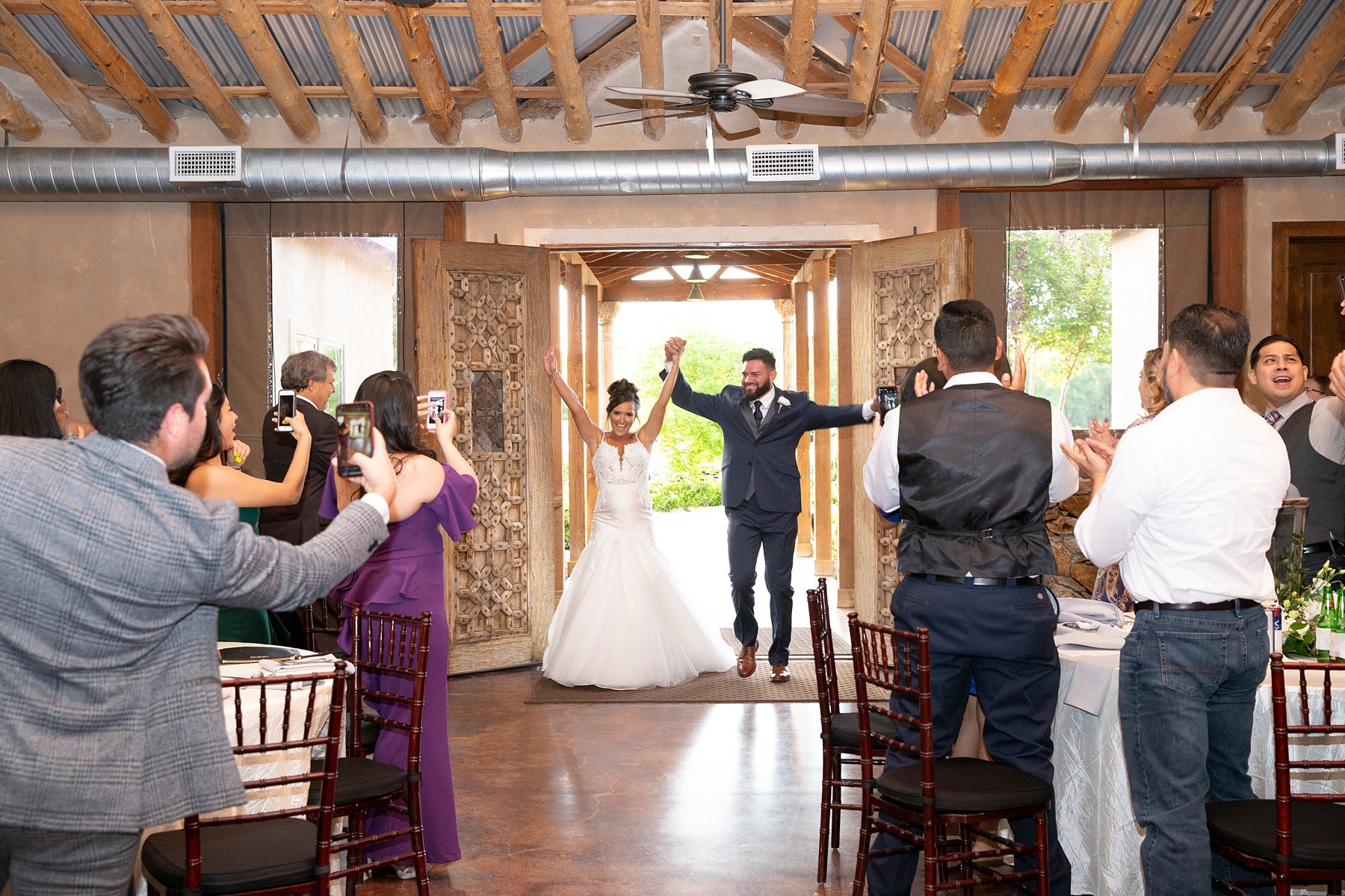 bride and groom enter Brooks at Weatherford wedding reception photographed by Randi Michelle