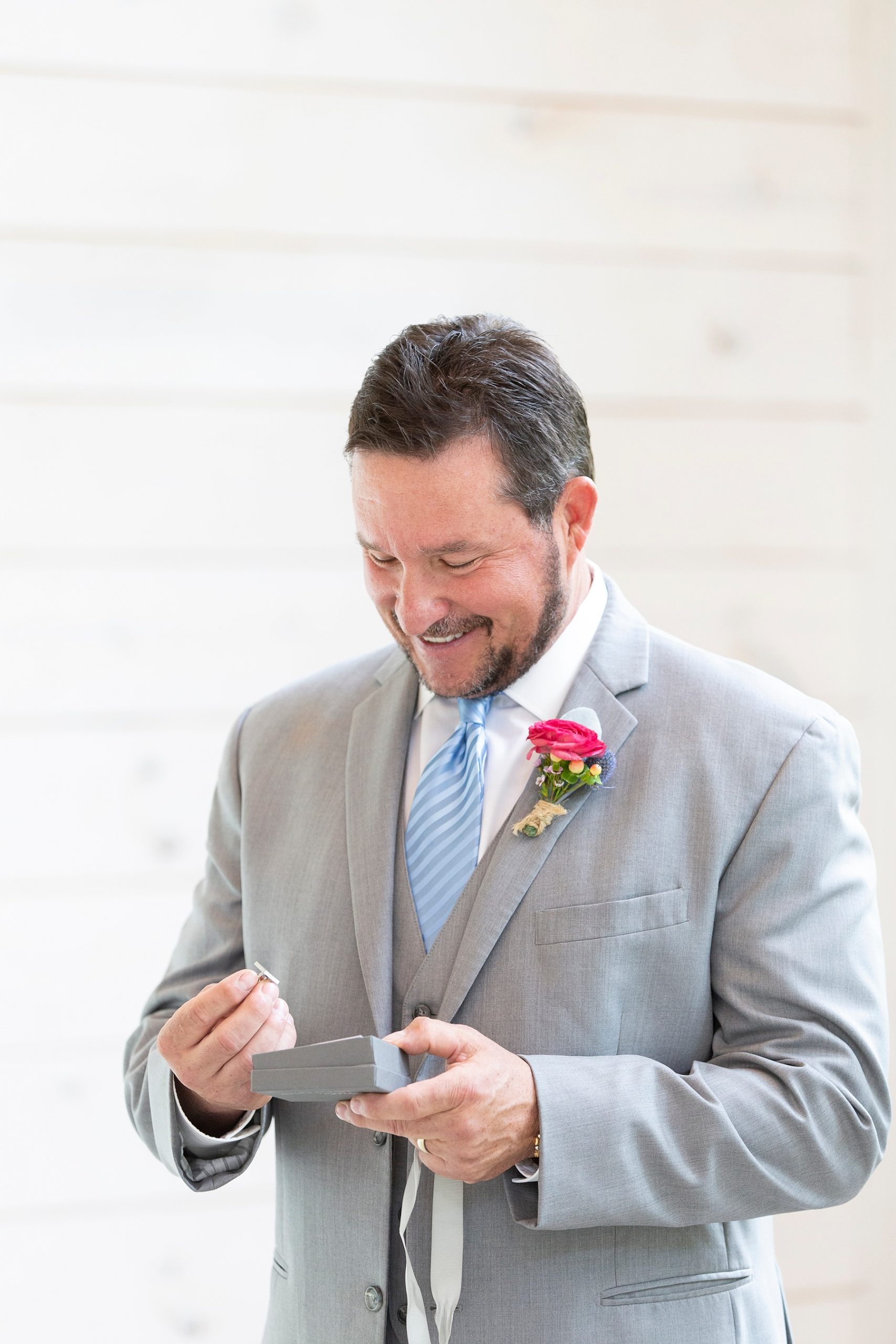 dad of the bride opens gift during first look photographed by Randi Michelle Weddings