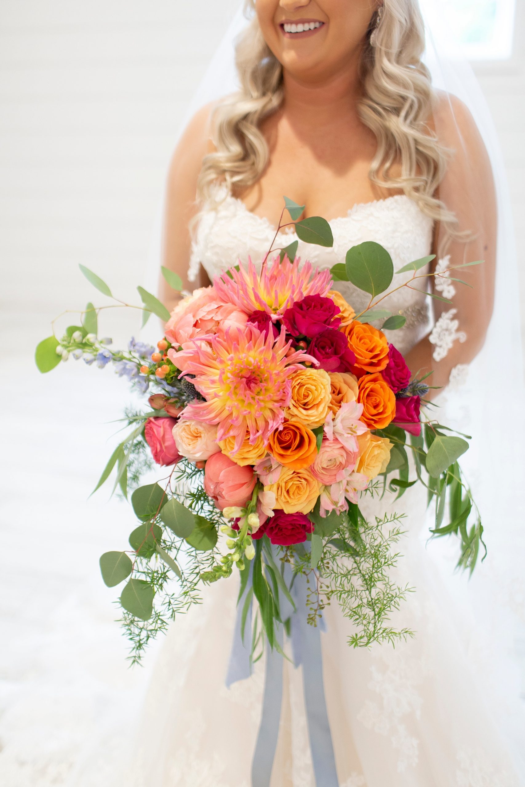 bride with bright wedding bouquet photographed by Randi Michelle Weddings