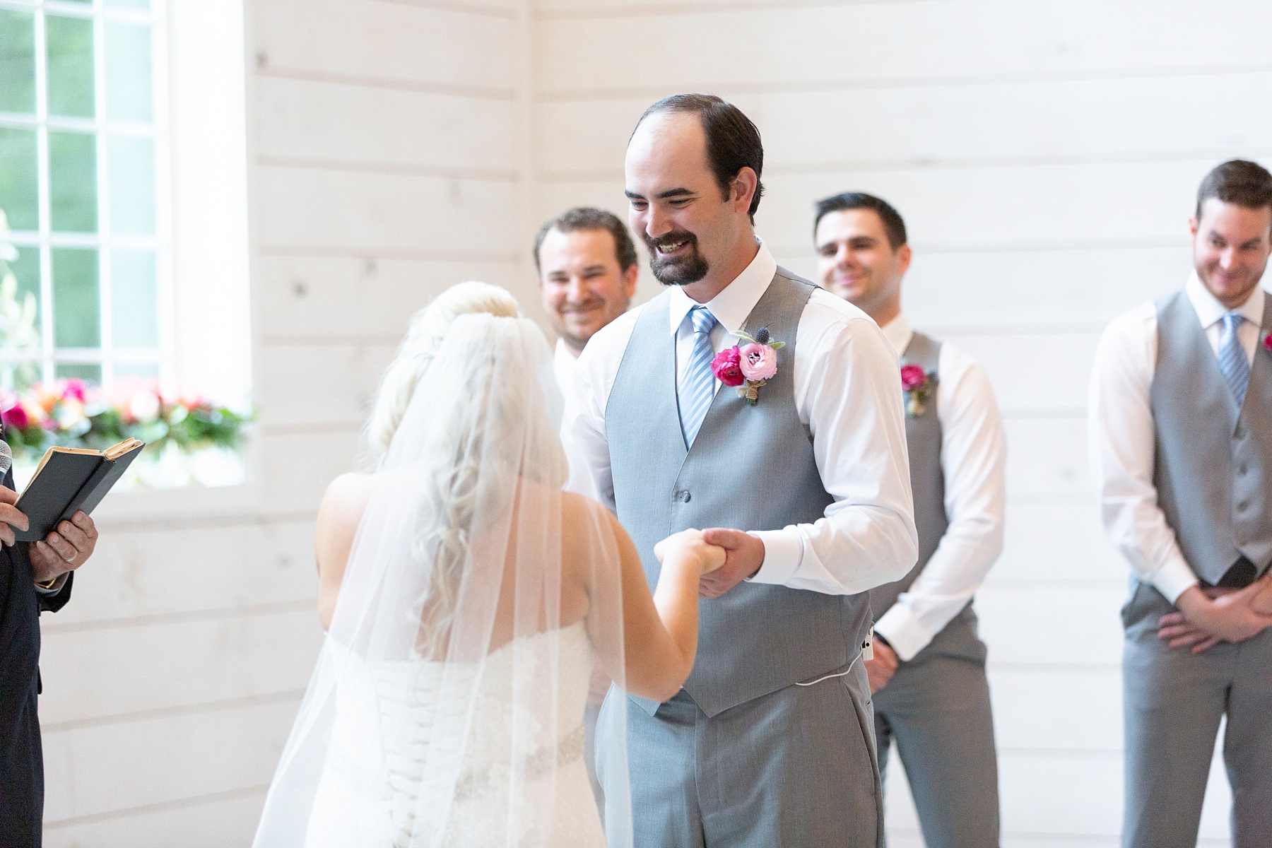 groom smiles at bride while exchanging vows at the Establishment Barn photographed by Randi Michelle Weddings