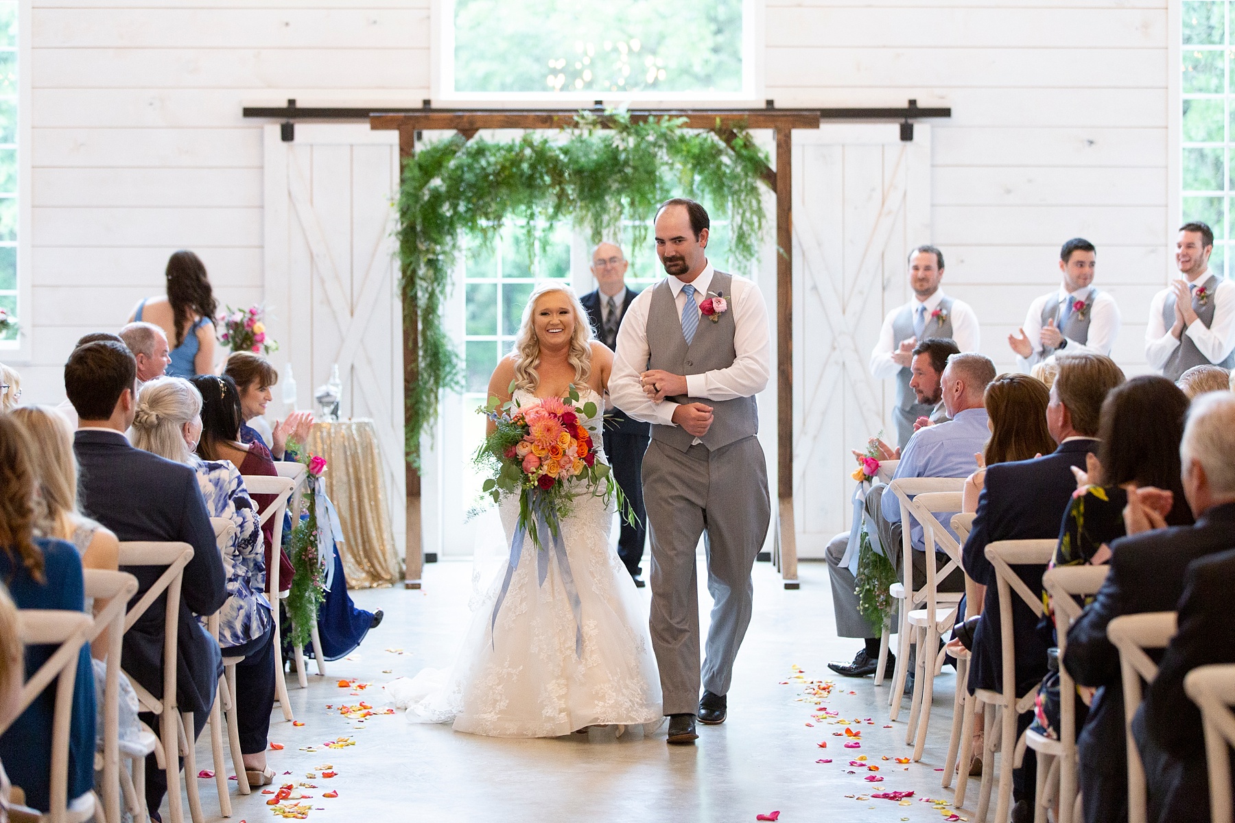 bride and groom walk up aisle at the Establishment Barn photographed by Randi Michelle Weddings