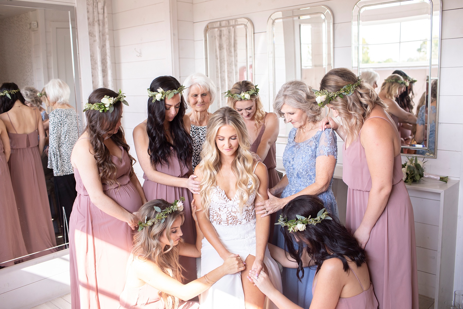 women and bridesmaids pray with bride before TX wedding photographed by Randi Michelle