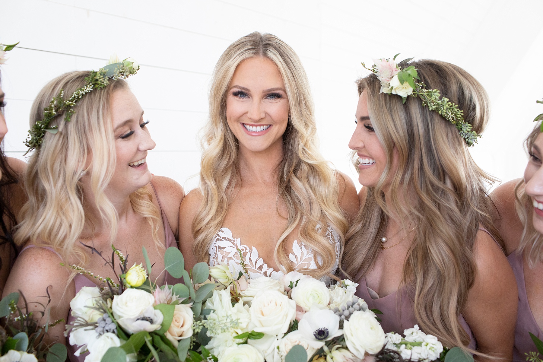 bride poses with bridesmaids wearing flower crowns photographed by Randi Michelle