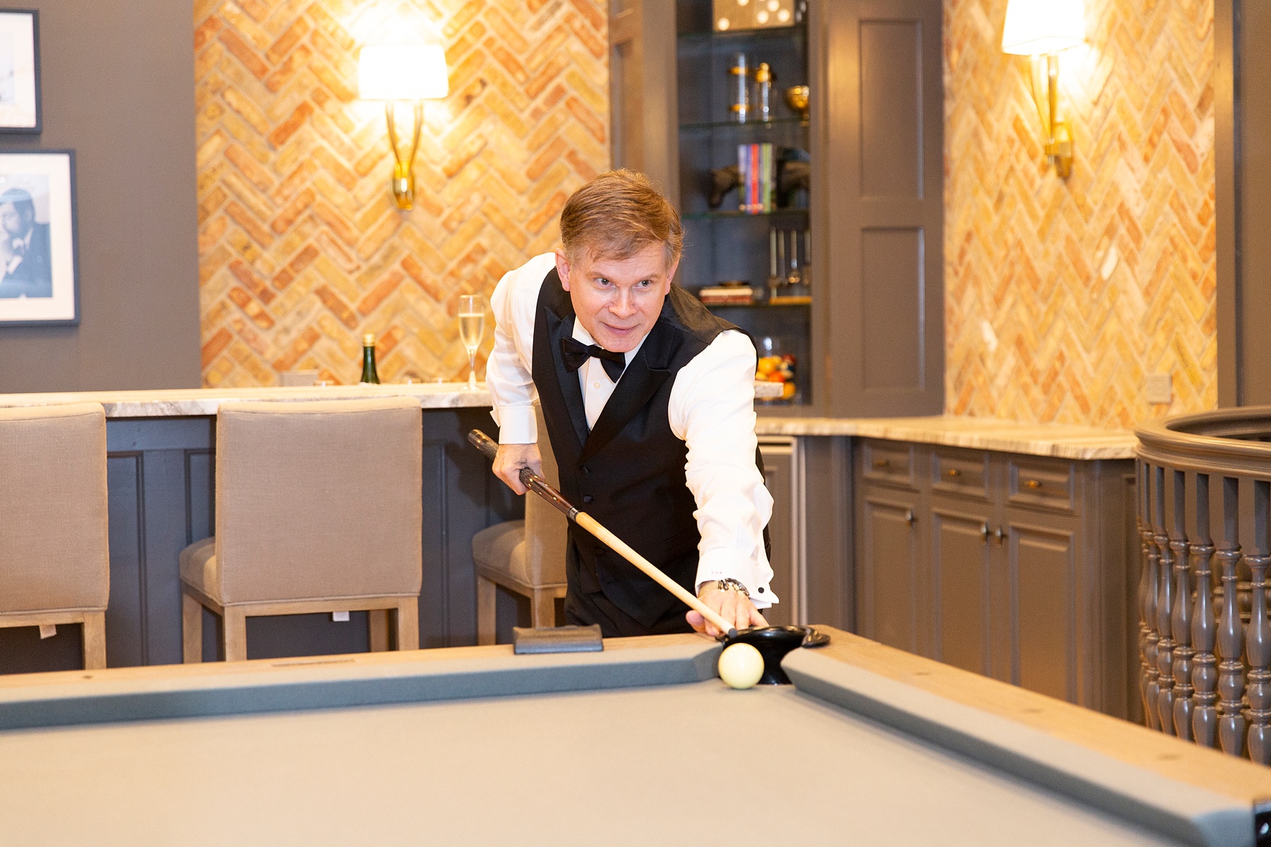 groom plays pool before Hickory Creek TX wedding photographed by Randi Michelle