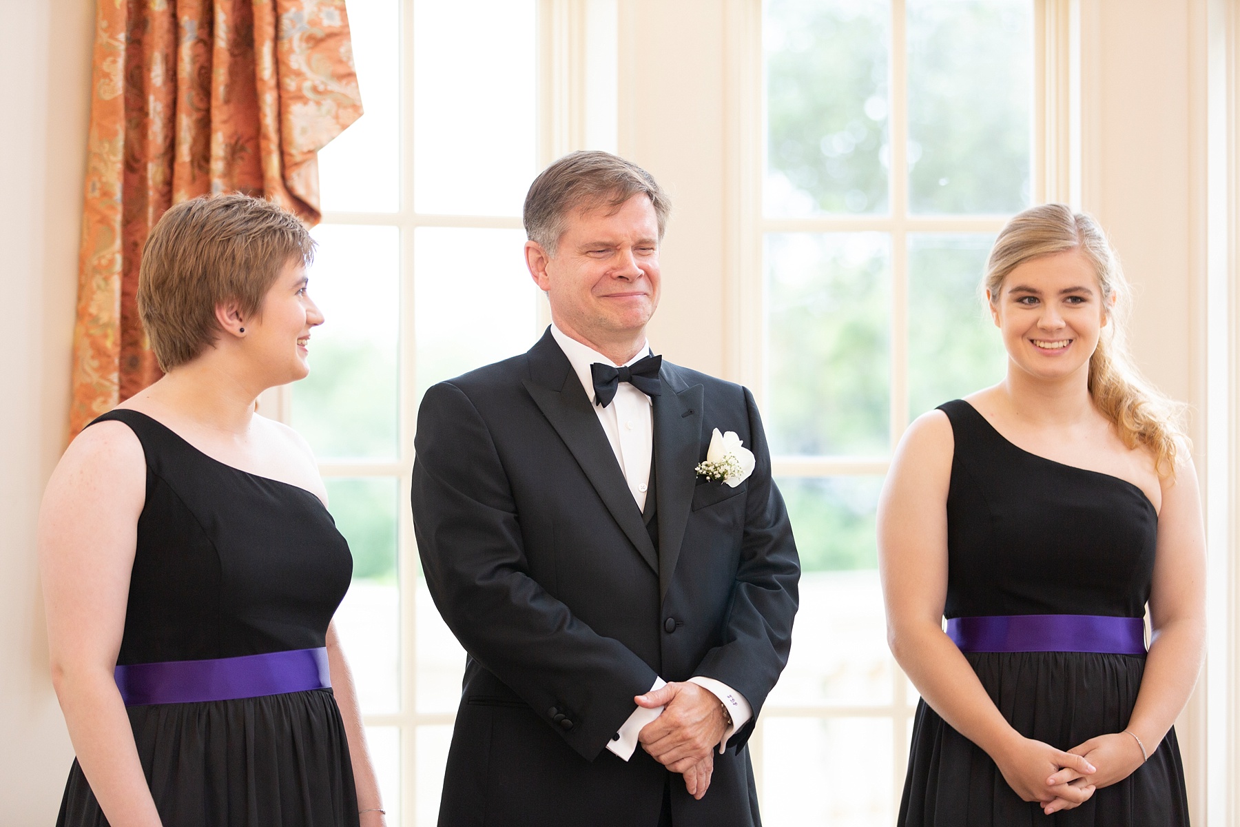 groom waits with daughters to see bride during first look photographed by Randi Michelle Weddings