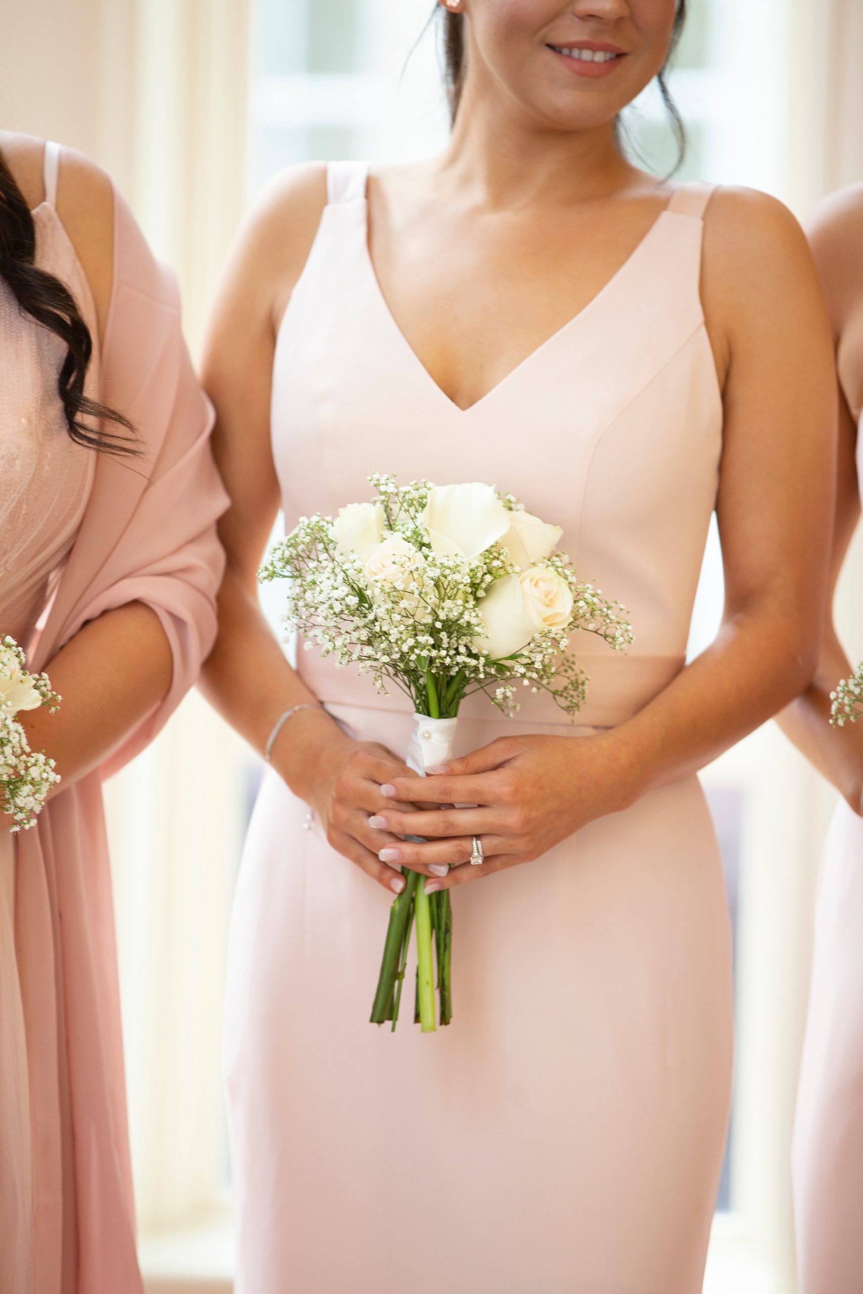 ivory roses in bridesmaids' bouquets photographed by Randi Michelle Weddings