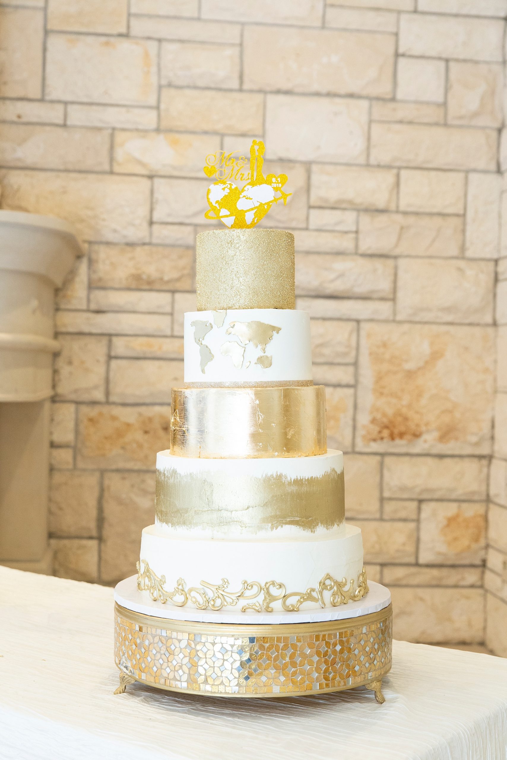 gold and ivory travel inspired wedding cake photographed by Randi Michelle Weddings