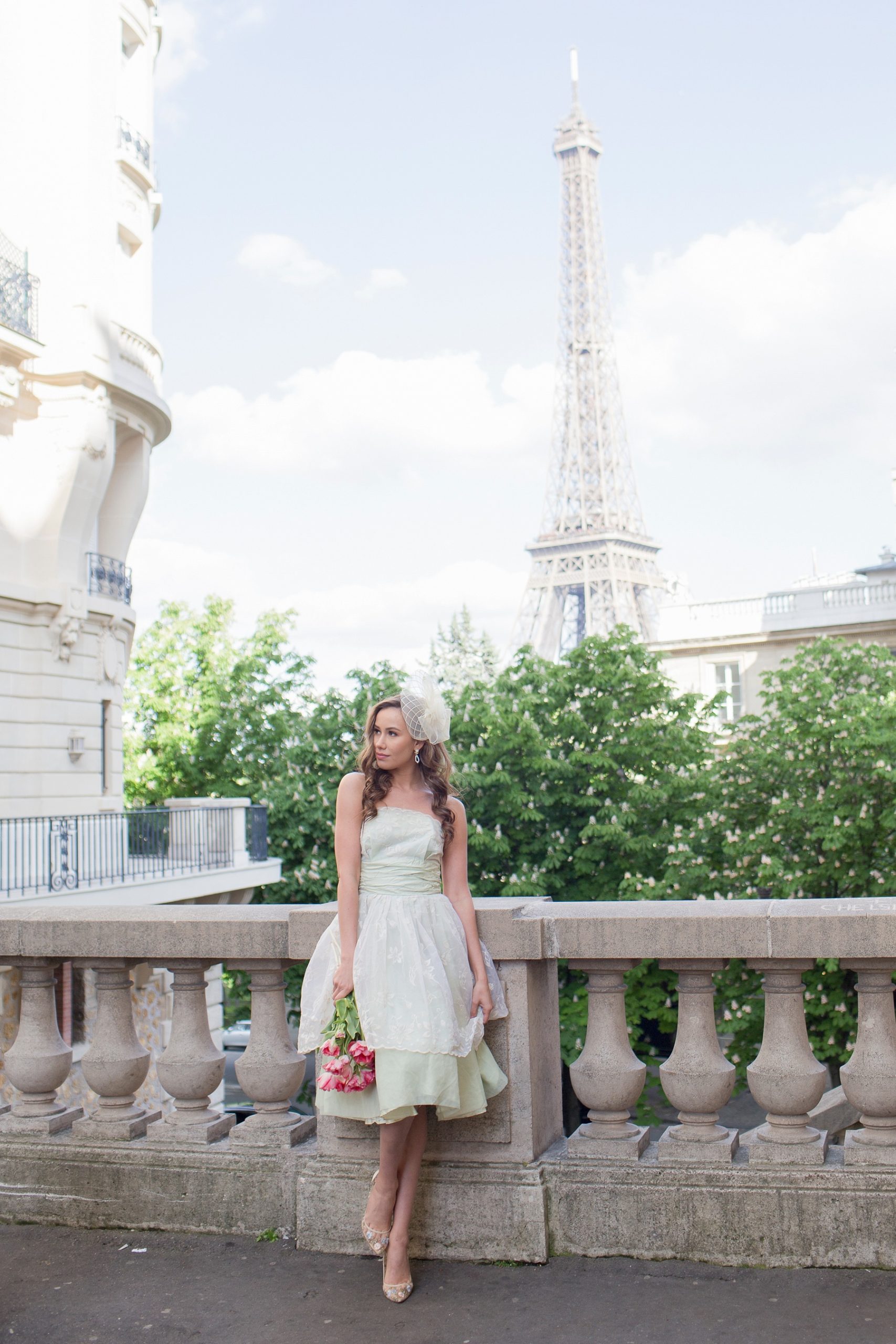 bride-to-be poses in mint green strapless gown and hat near Eiffel Tower with Randi Michelle