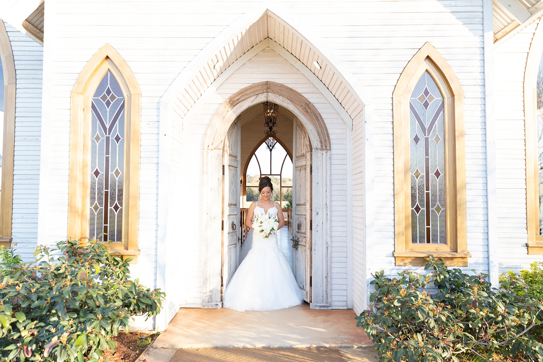 bride poses in chapel at the Brooks at Weatherford photographed by destination wedding photographer Randi Michelle