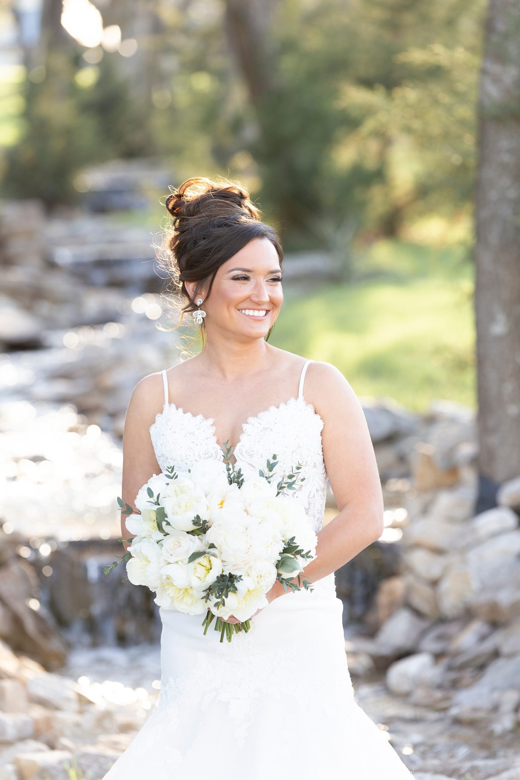 The Brooks at Weatherford bridal portraits of bride in lace gown with all-white bouquet by Randi Michelle