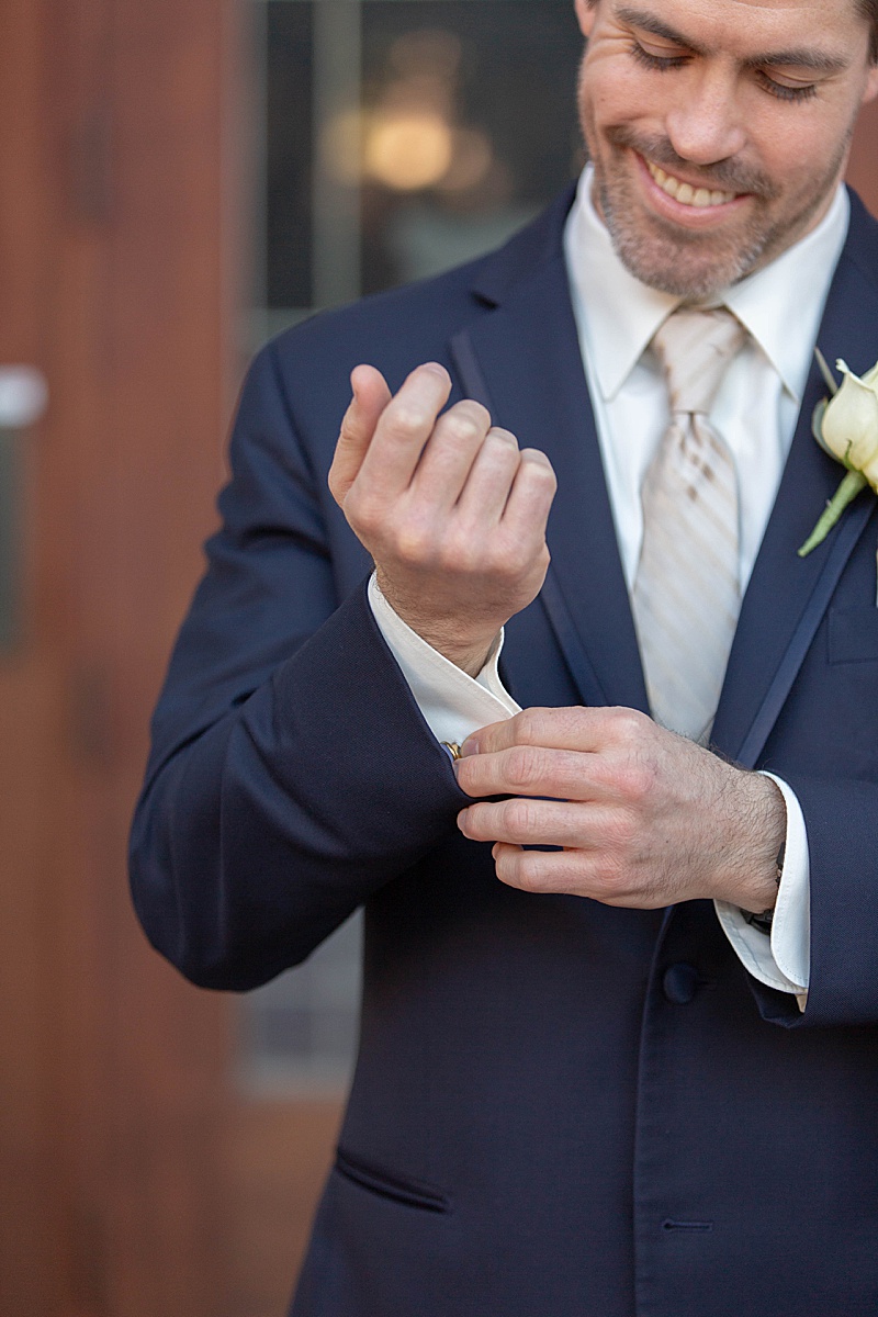 groom adjusts cufflinks in Fort Worth TX