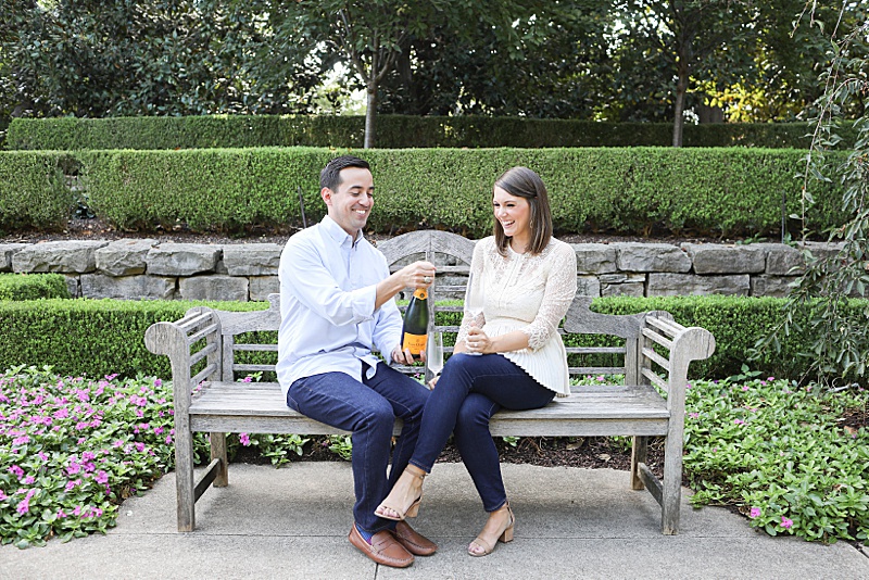 groom-to-be pops cork on champagne photographed by Randi Michelle