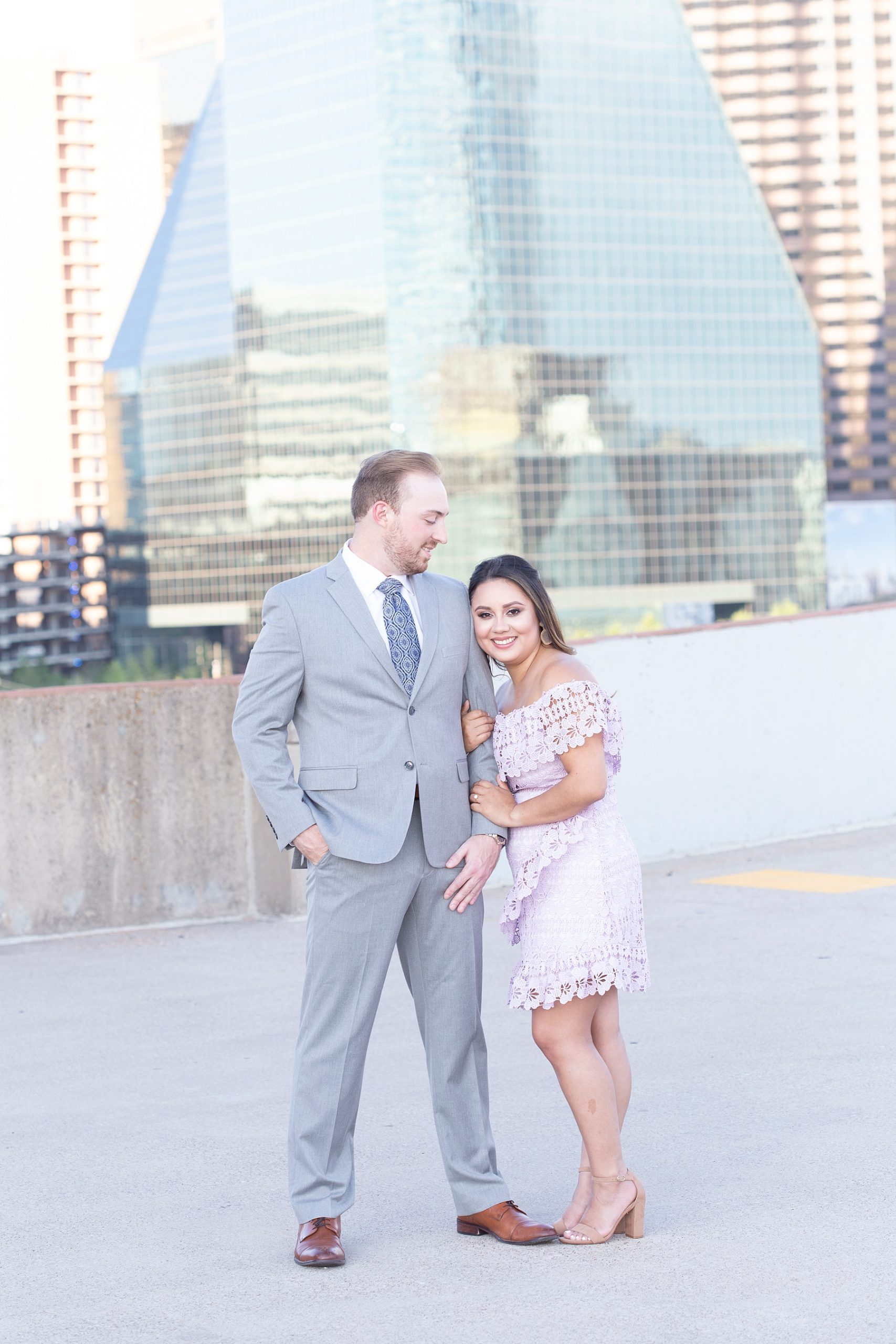 bride leans against groom during engagement portraits in Texas