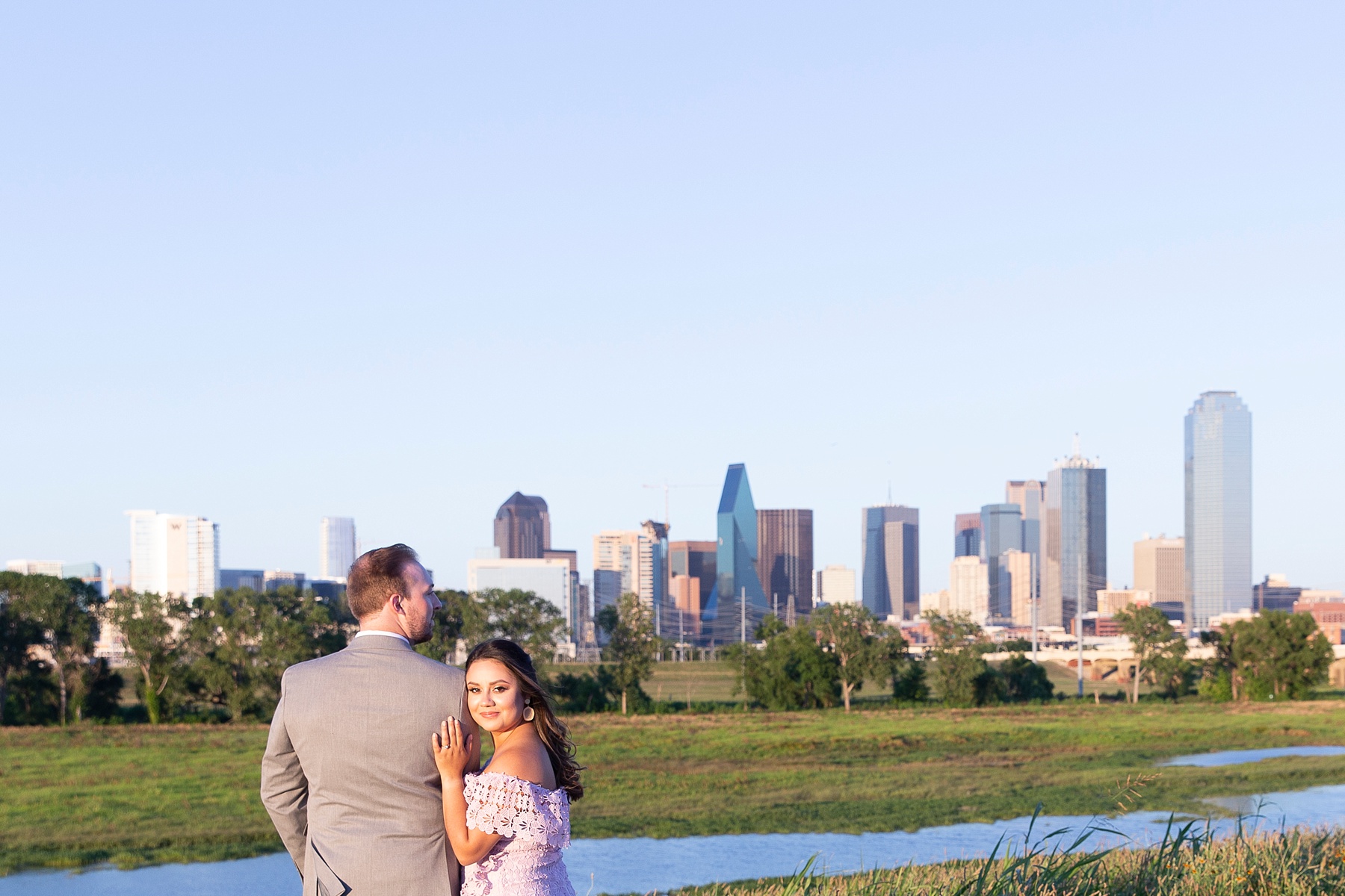 bride looks at Randi Michelle Weddings during Dallas TX engagement photos