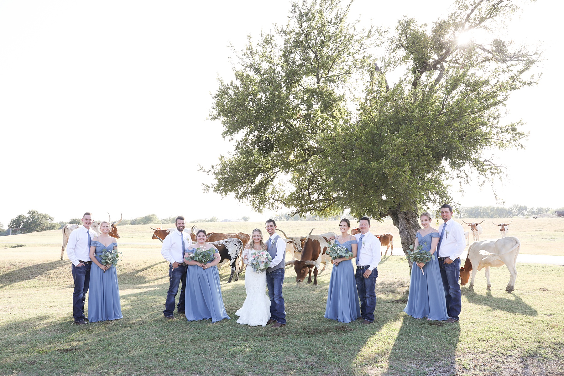 bridal party in blue dresses pose at Lucky Spur Ranch with Randi Michelle Weddings