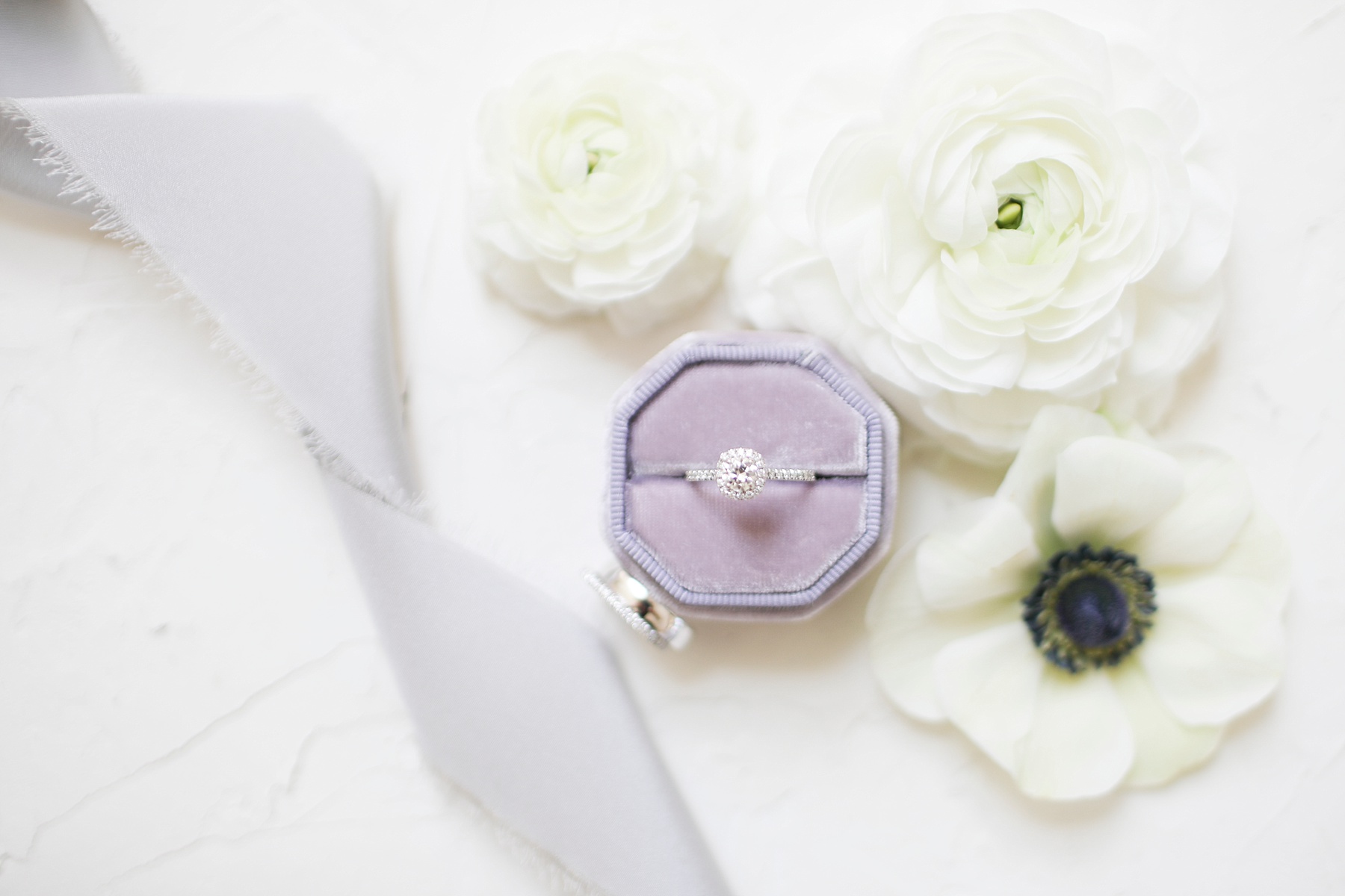 bride's engagement ring in purple box photographed by Randi Michelle Weddings