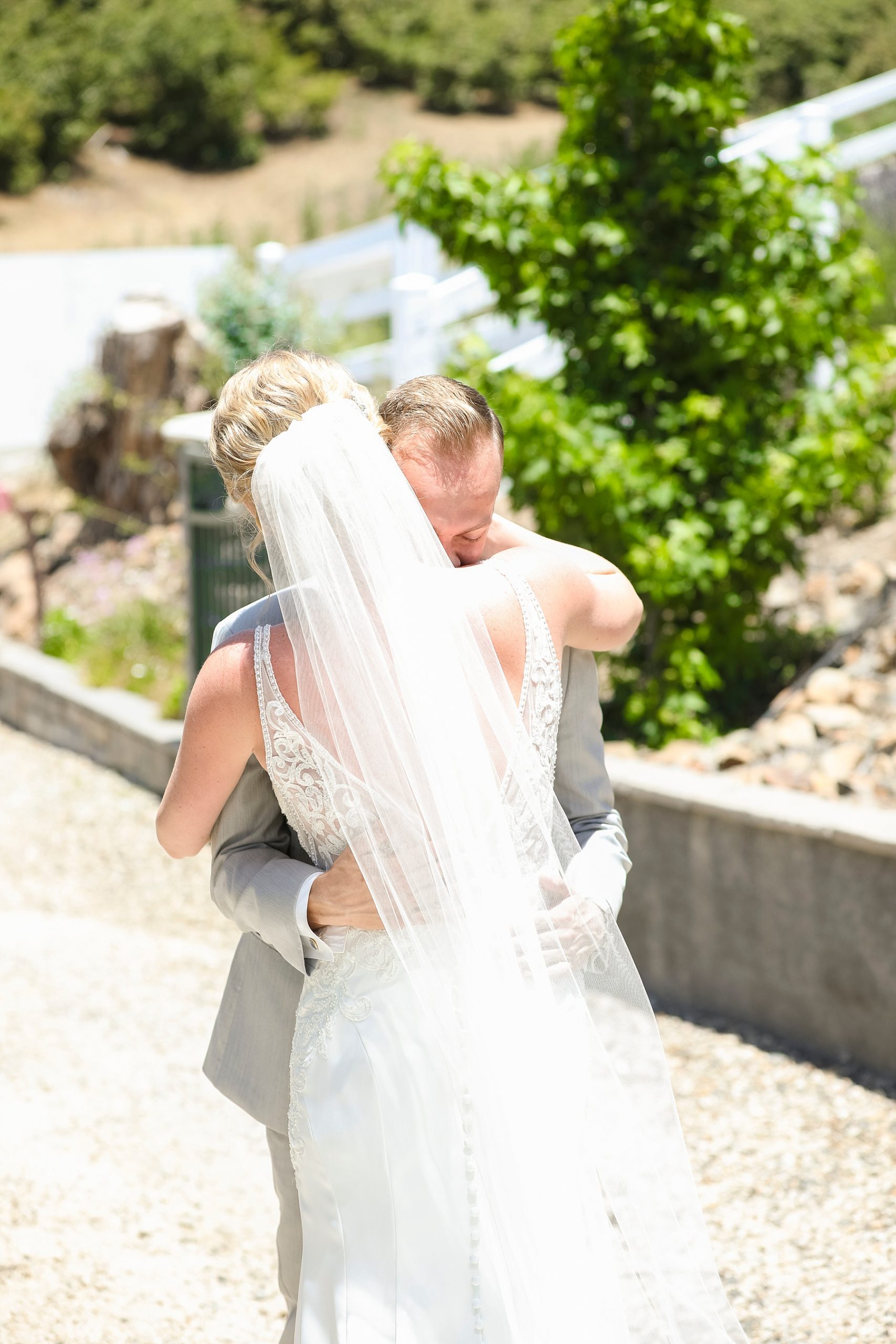 bride and groom hug during first look at CA wedding venue