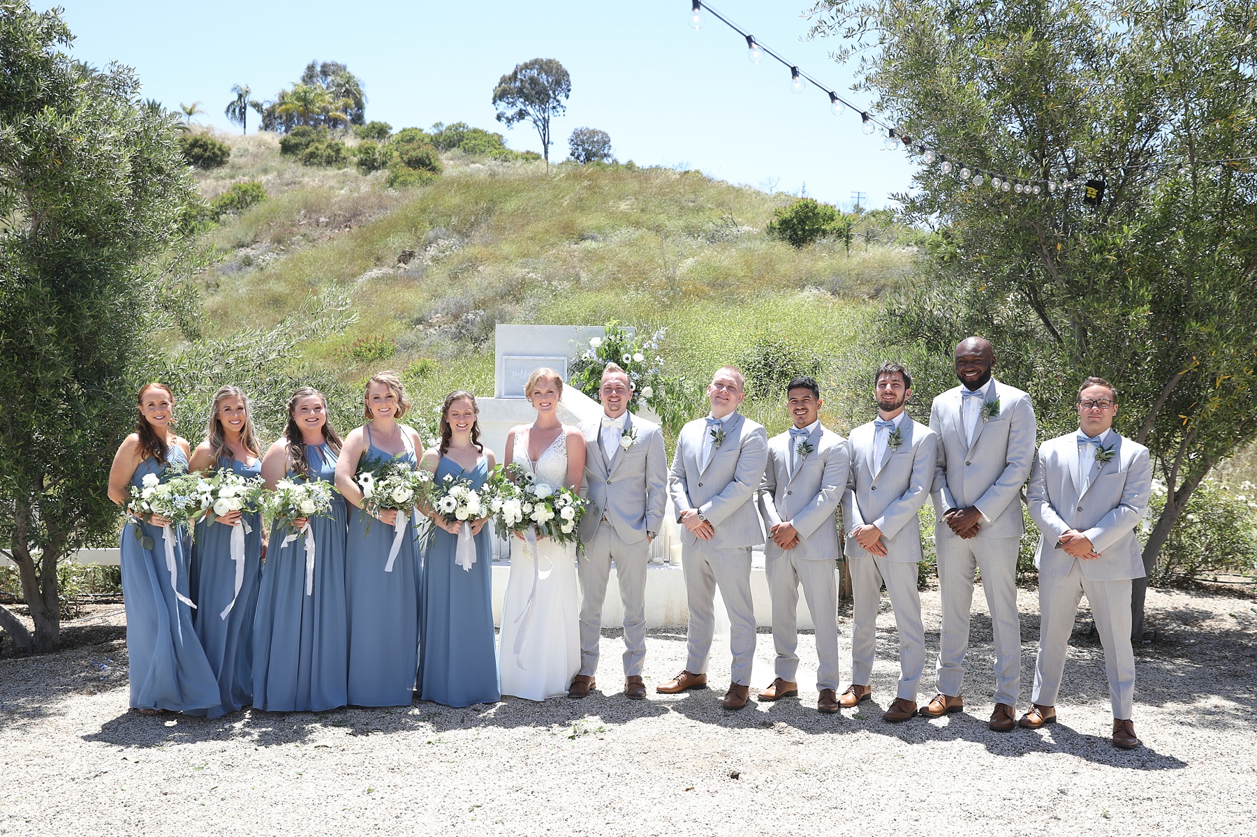 bridal party portraits in front of ceremony site with Randi Michelle Weddings