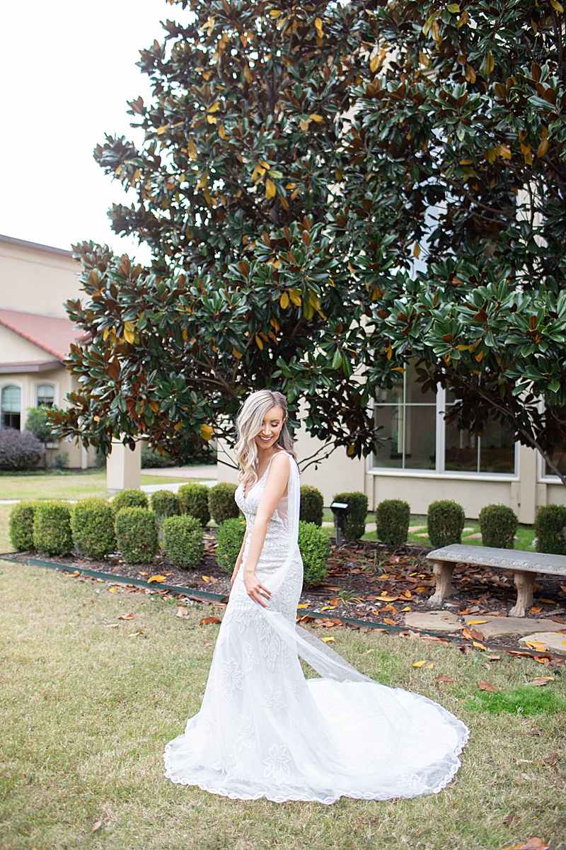 bride twirls with back drape of wedding dress at Chapel at Ana Villa