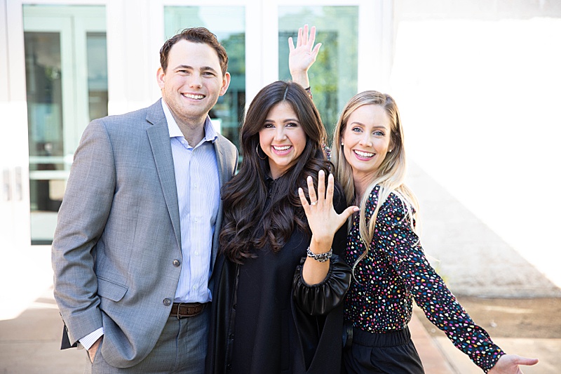 newly engaged couple poses with Randi Michelle