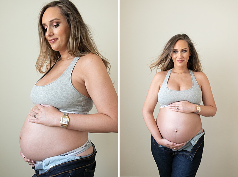mom in sports bra with jeans poses for maternity session