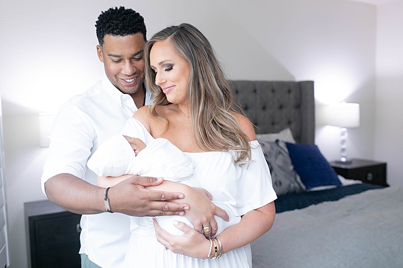 parents hold new baby boy during Dallas TX Lifestyle Newborn Session