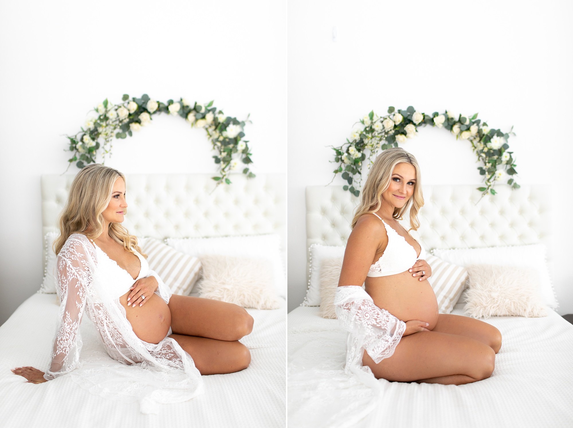 pregnant woman sits on white bed holding baby belly