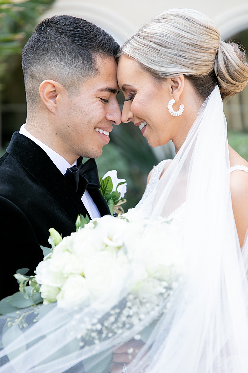bride and groom touch foreheads during TX wedding portraits