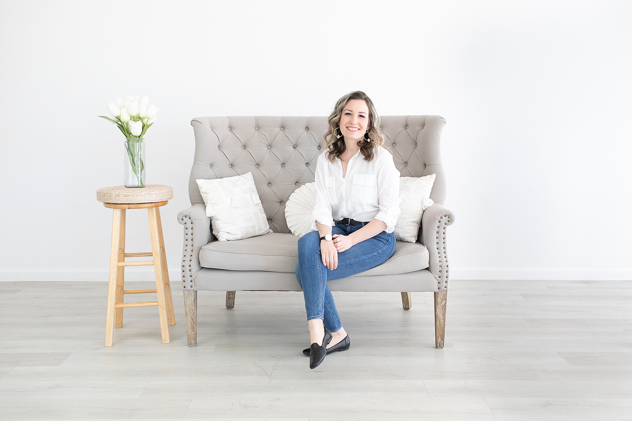 branding portraits on grey couch for female business owner