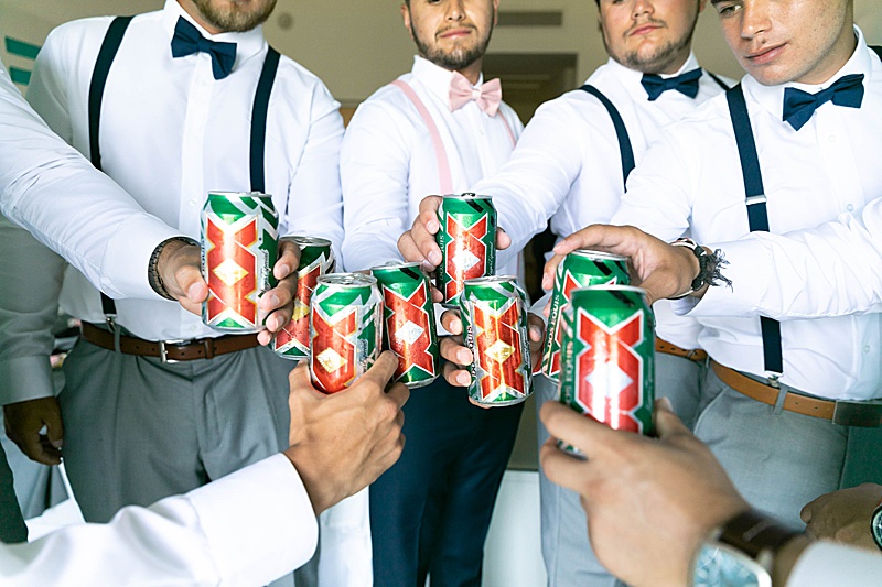 groom and groomsmen toast with Dos Equis