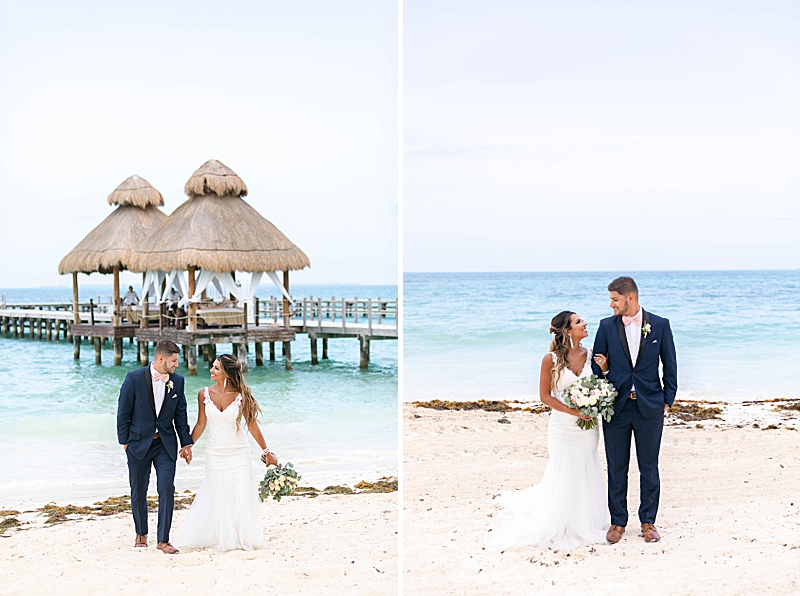 bride and groom pose beside blue ocean in Mexico