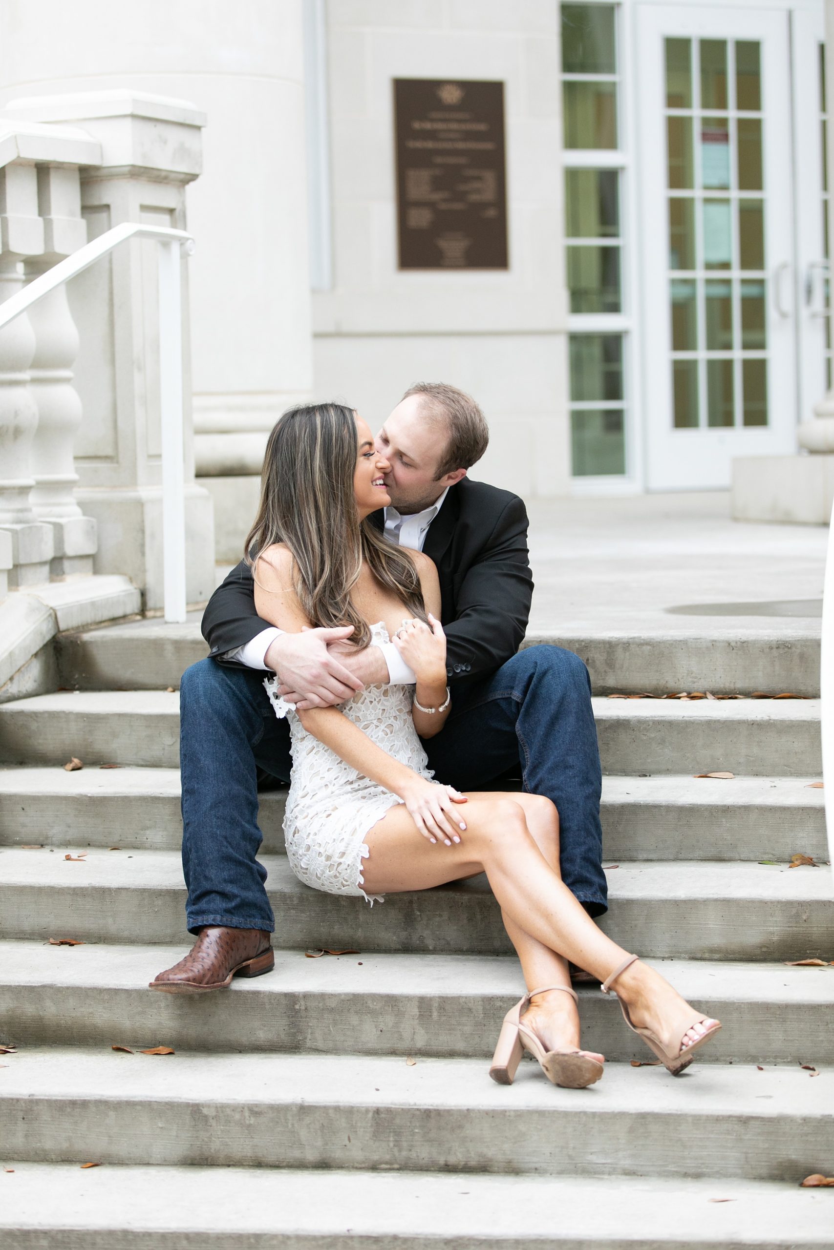 groom kisses bride on staircase at SMU Dallas