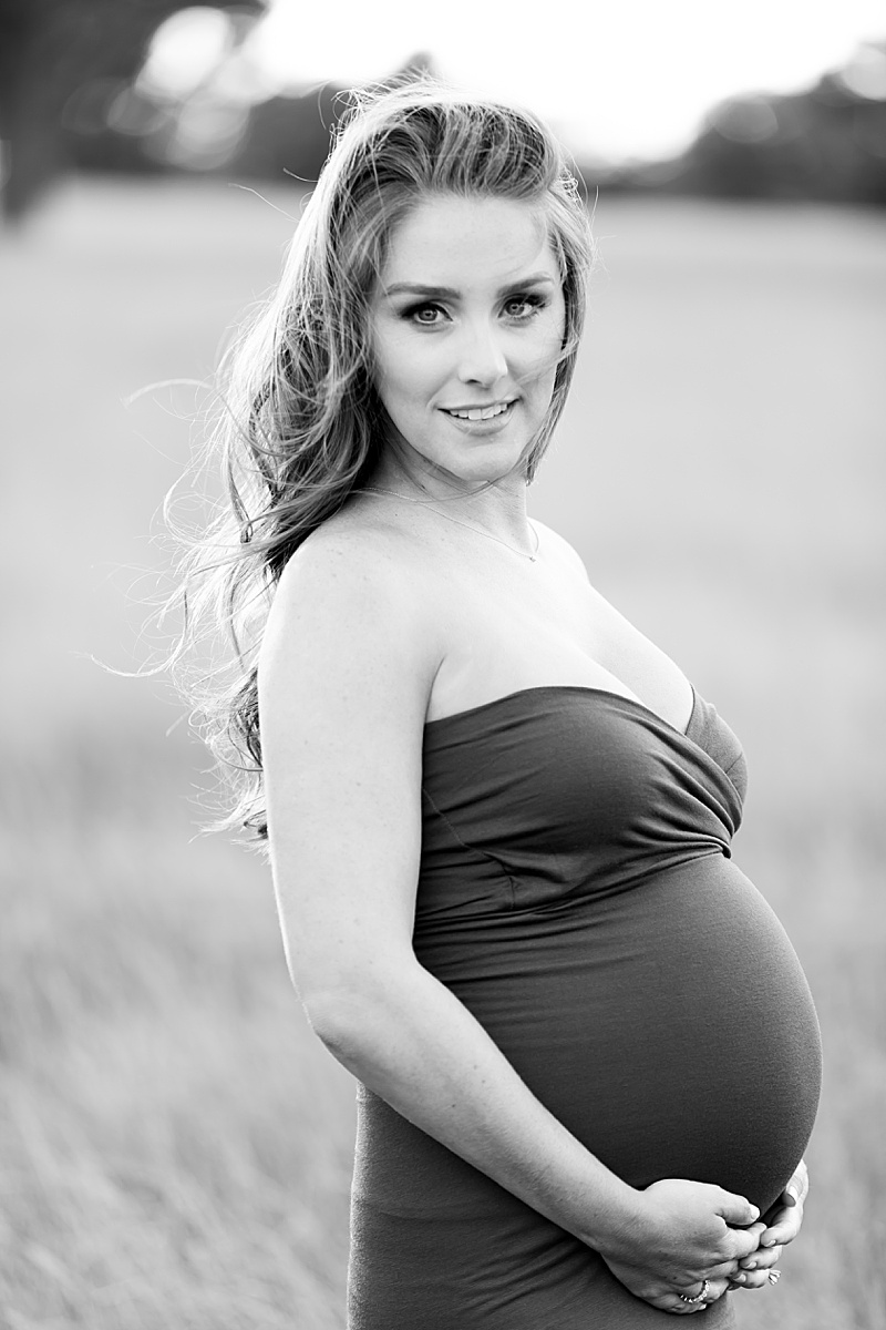 black and white portrait of mom in maternity gown in field