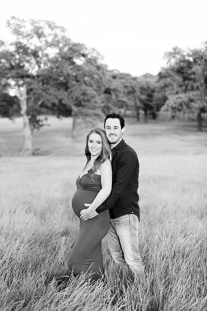 maternity portraits of mom and dad in Texas field