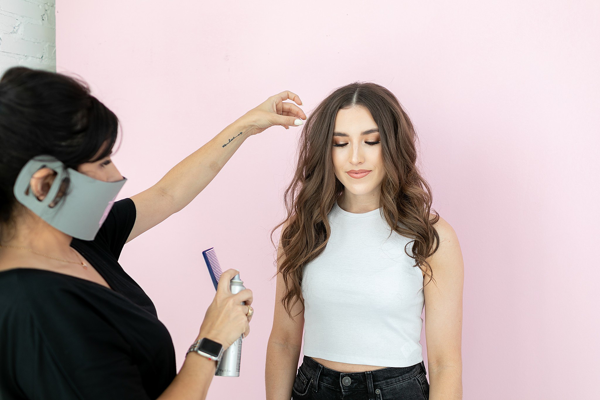 makeup artist in mask update's models hair