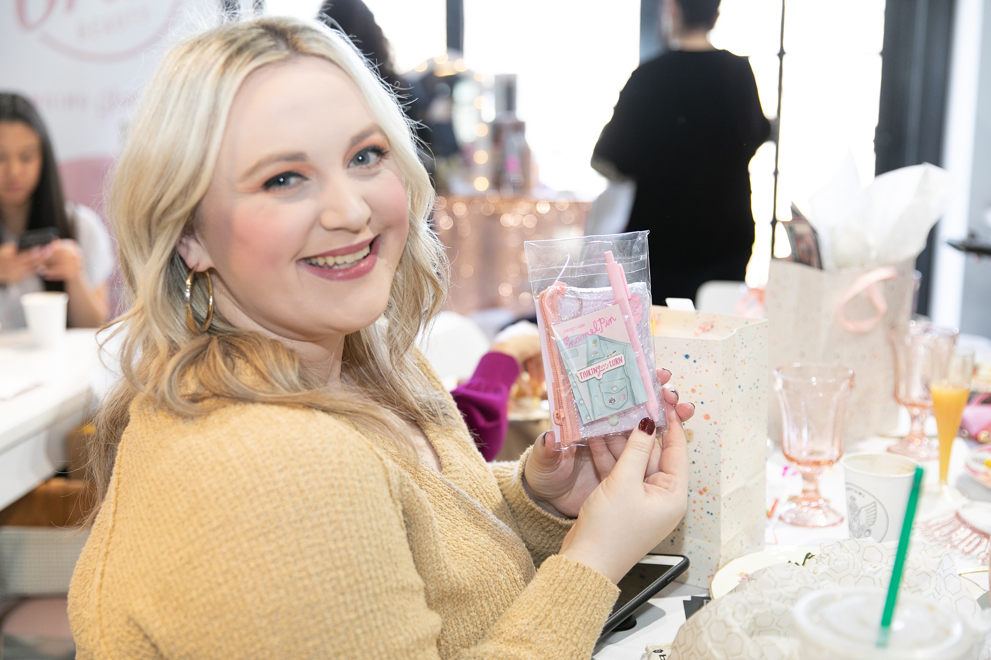 guests show off goodie bag from Galentine's Day event