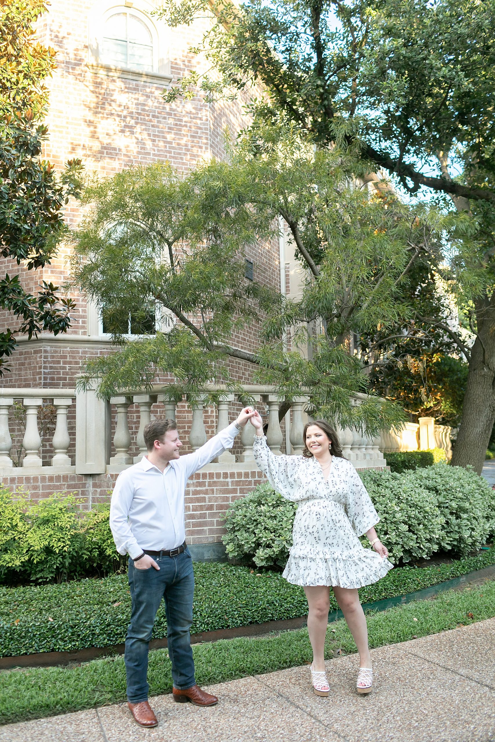 groom twirls bride during Texas engagement session