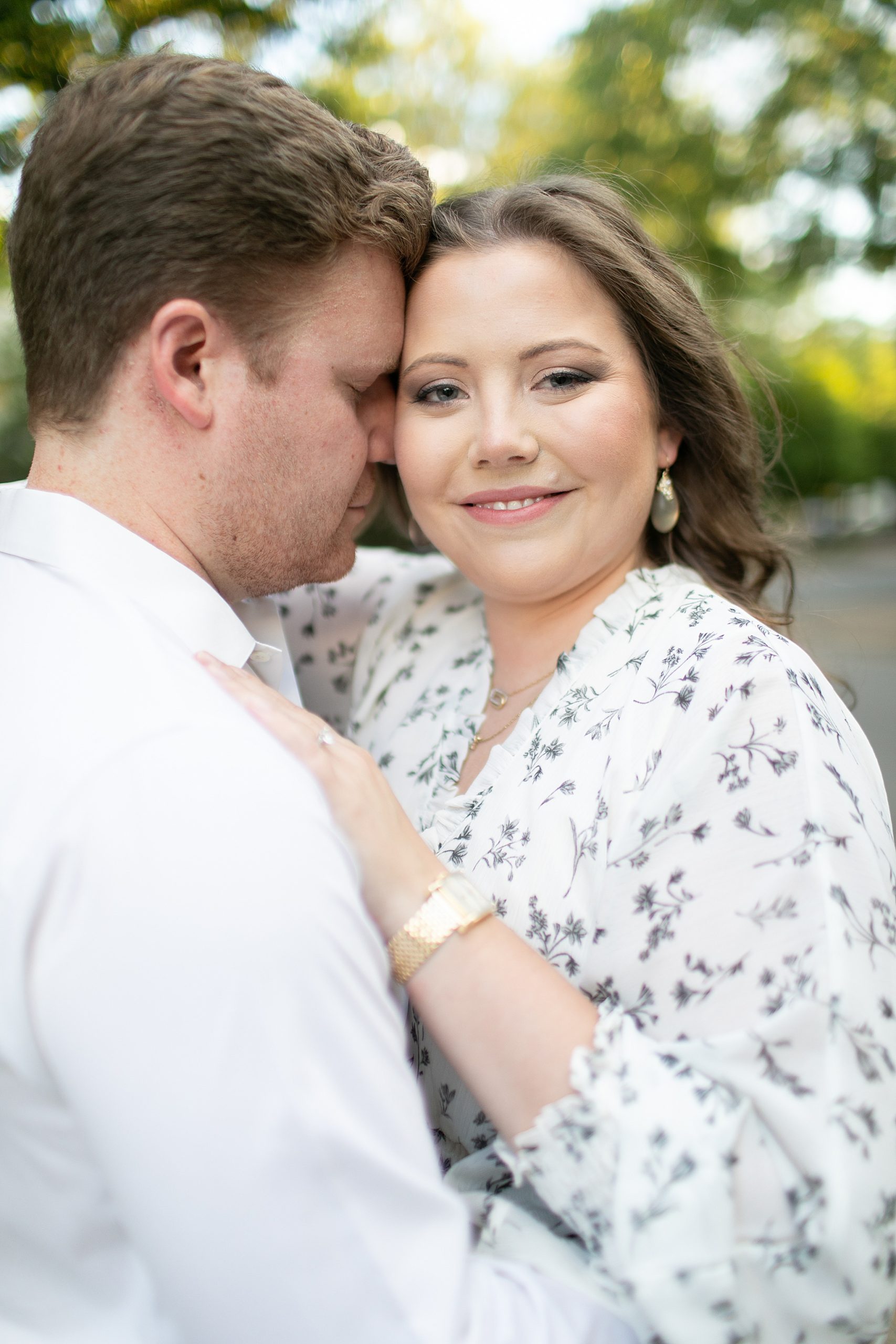 groom nuzzles bride during Texas engagement session