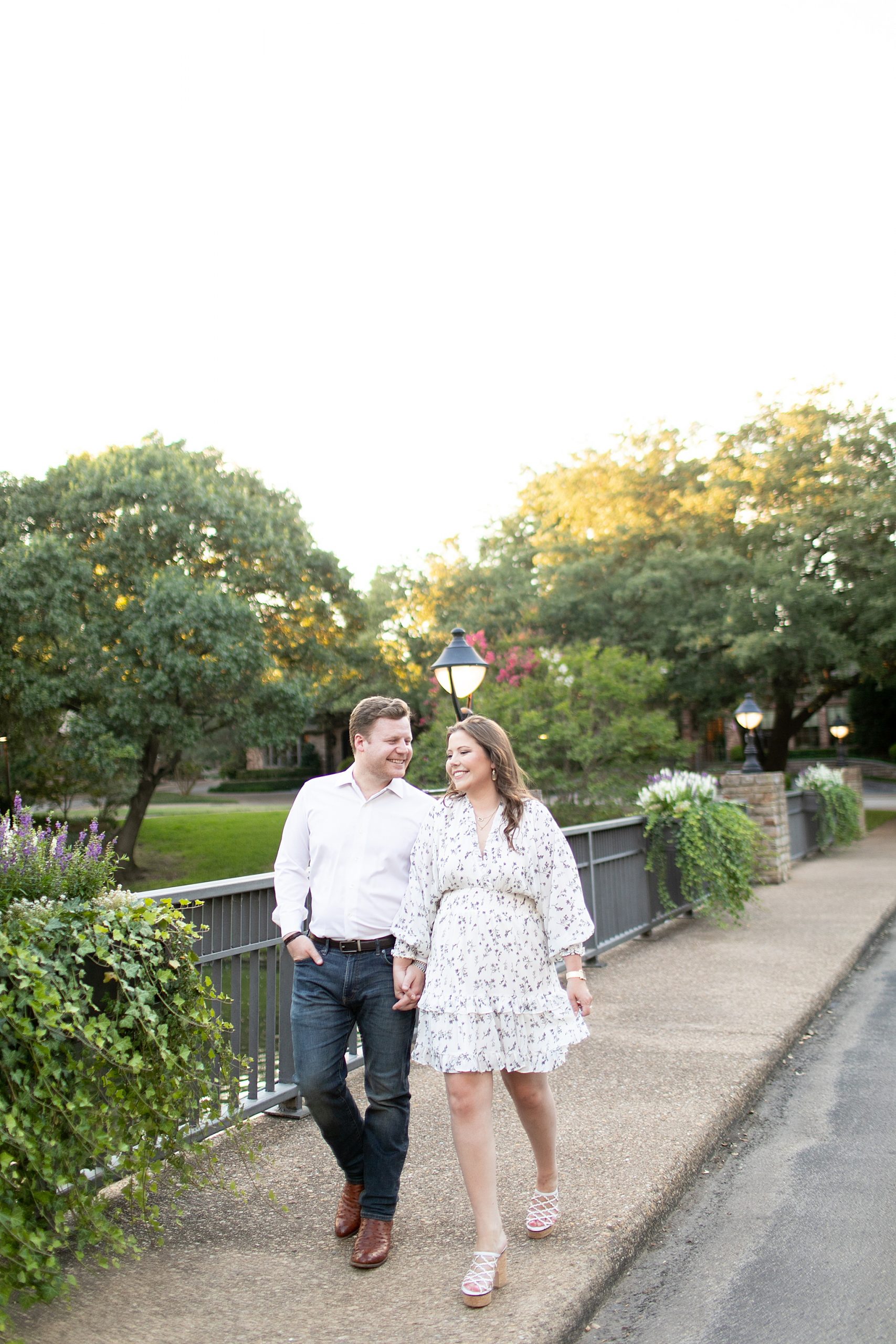 engaged couple walks over bridge in Texas