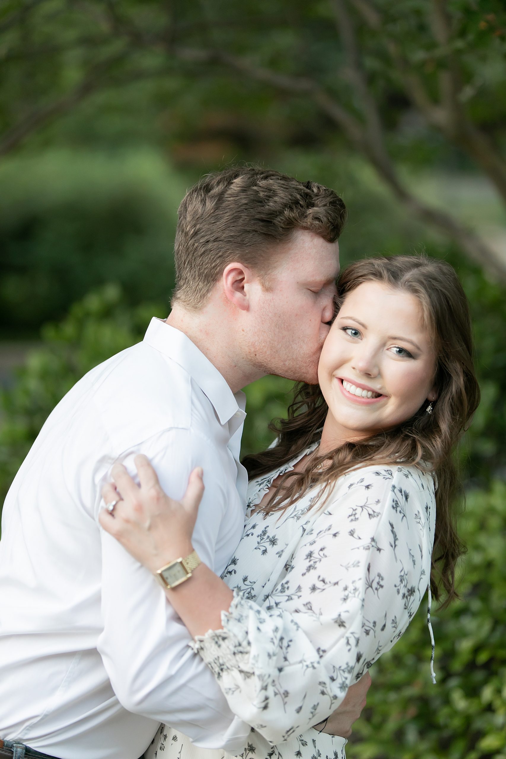 groom kisses bride's cheek during Texas engagement session