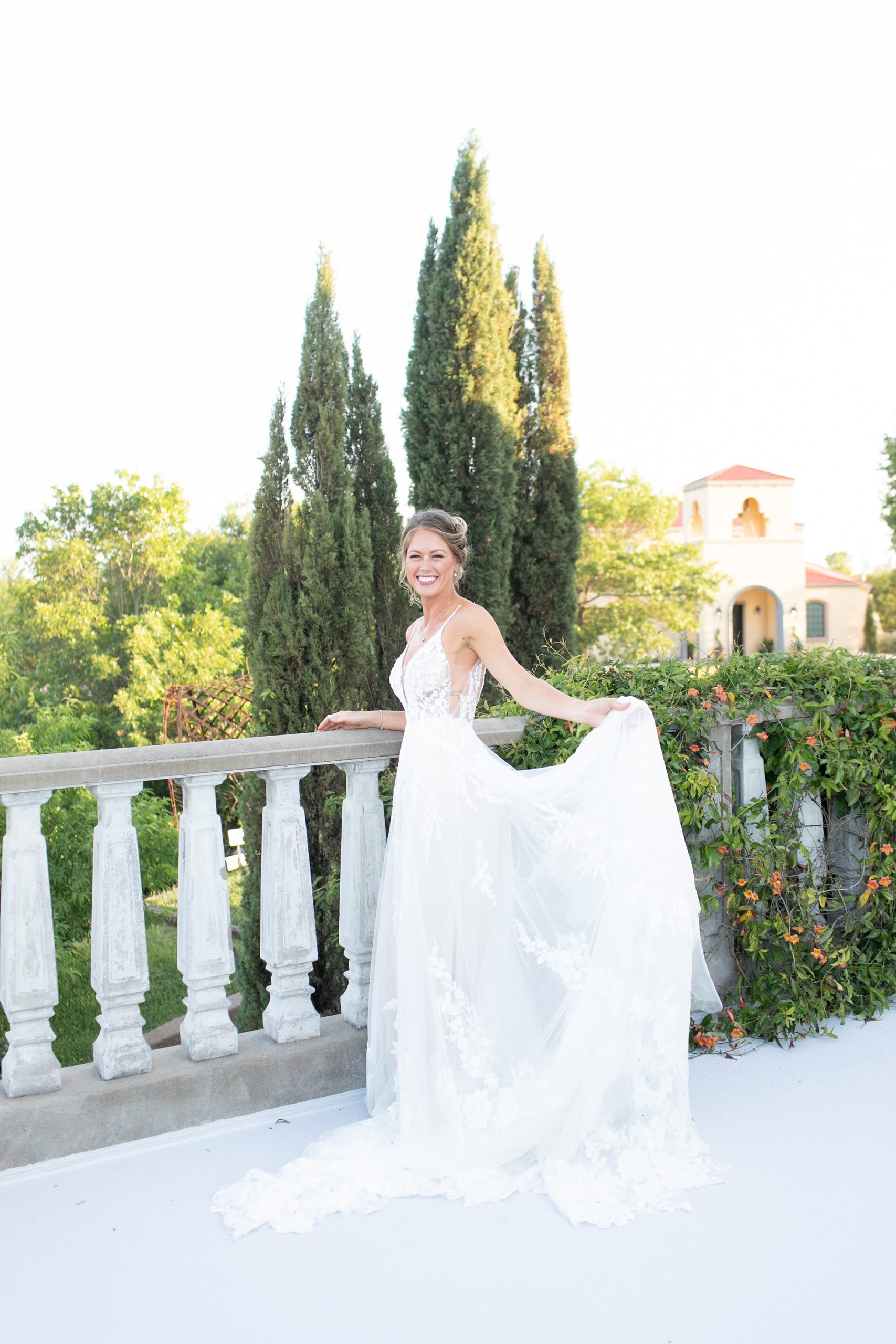 bride lifts wedding gown on balcony at Stoney Ridge Villa