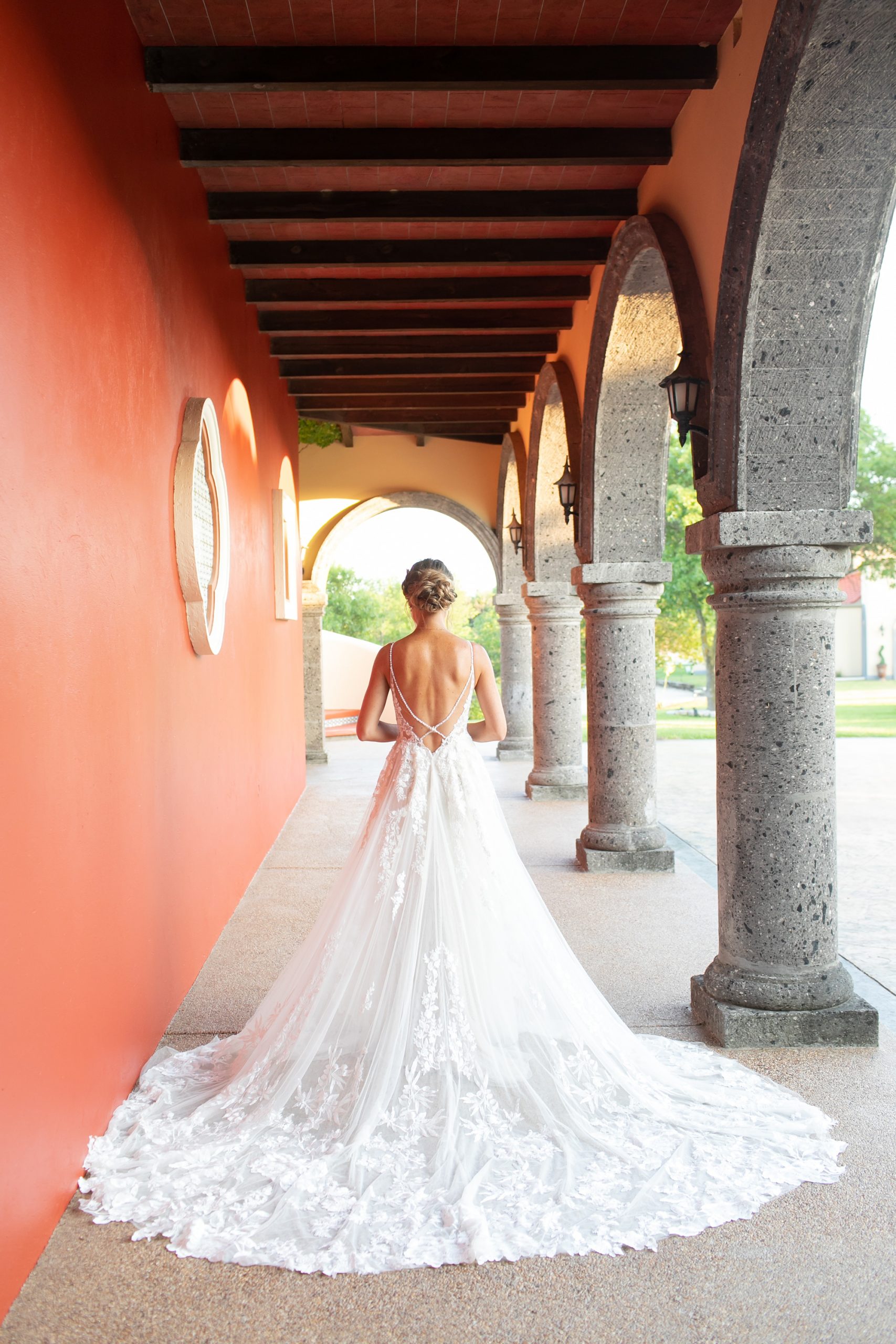 bride shows off back of wedding dress at Stoney Ridge Villa