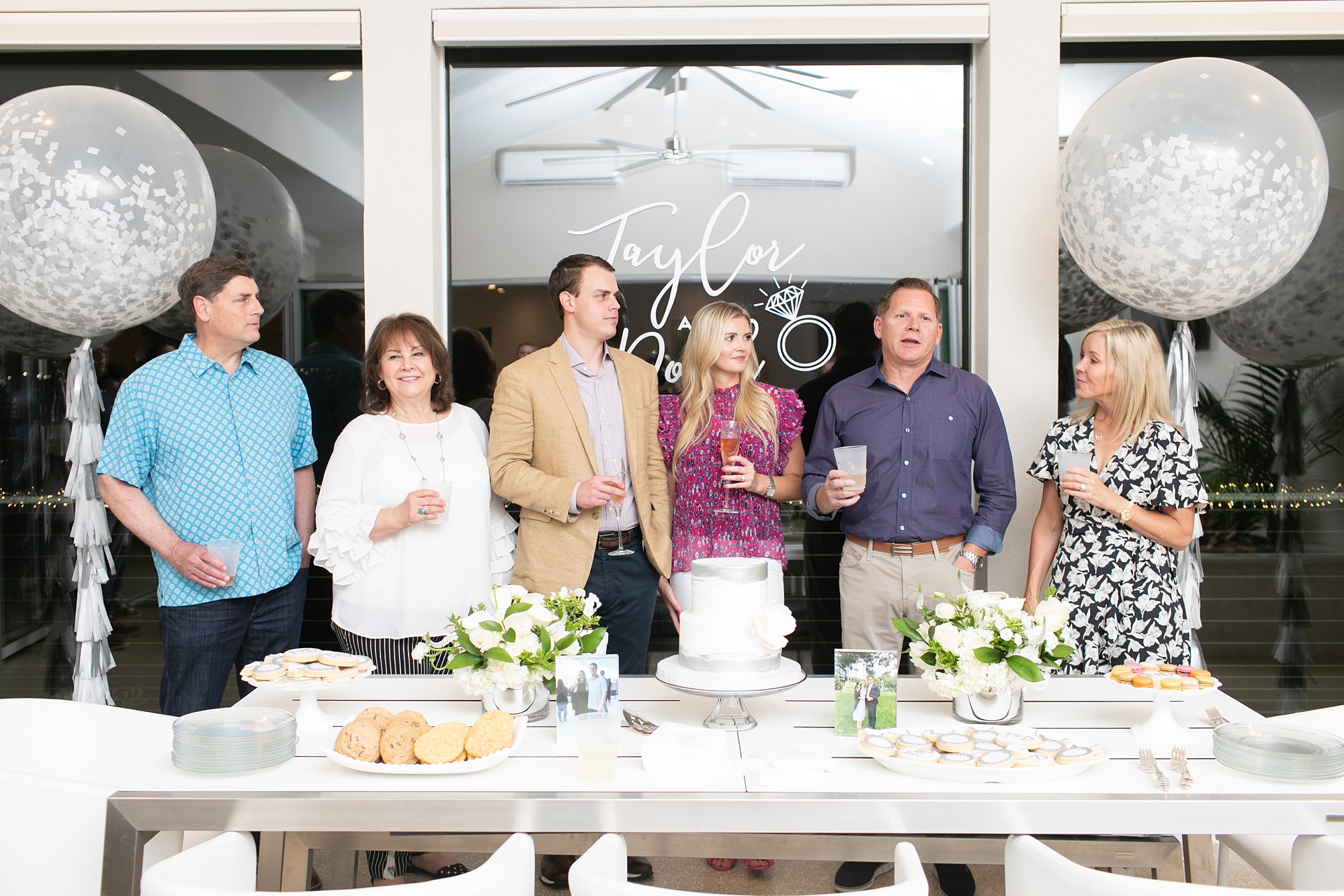 engaged couple and parents thank guests during Dallas surprise engagement party